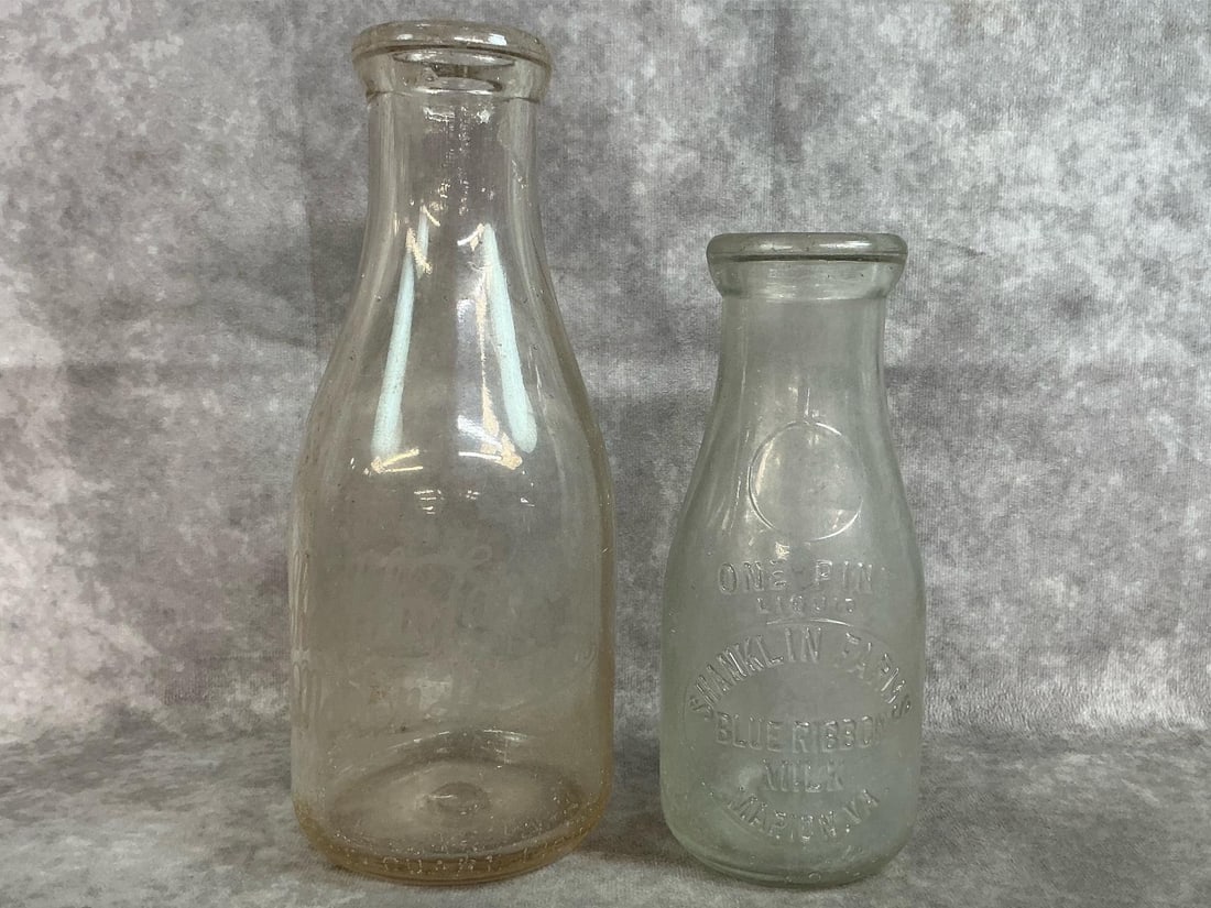 Marion VA Milk Bottles: Two 1930's local interest milk bottles from Marion VA. Embossed one pint milk bottle, Shanklin Farms Marion VA Blue Ribbon Milk. Bottom marked with a "M". One Quart bottle with faded lettering,