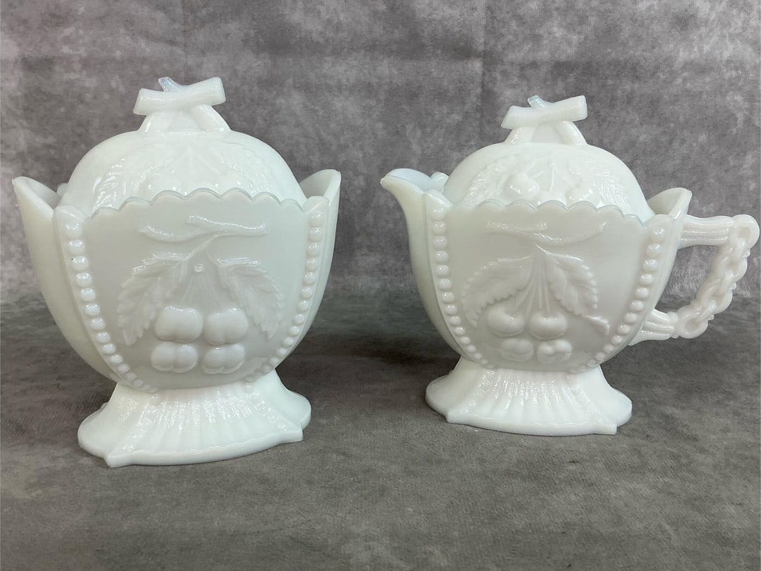 Westmoreland Sugar & Creamer: 1960's set of milk glass cream and sugar, made by Westmoreland. Cherry and grape pattern and numbered #2 and #3, both with lids. In good condition. Measures 4.5 inches wide x 2.5 x 5 inches tall.