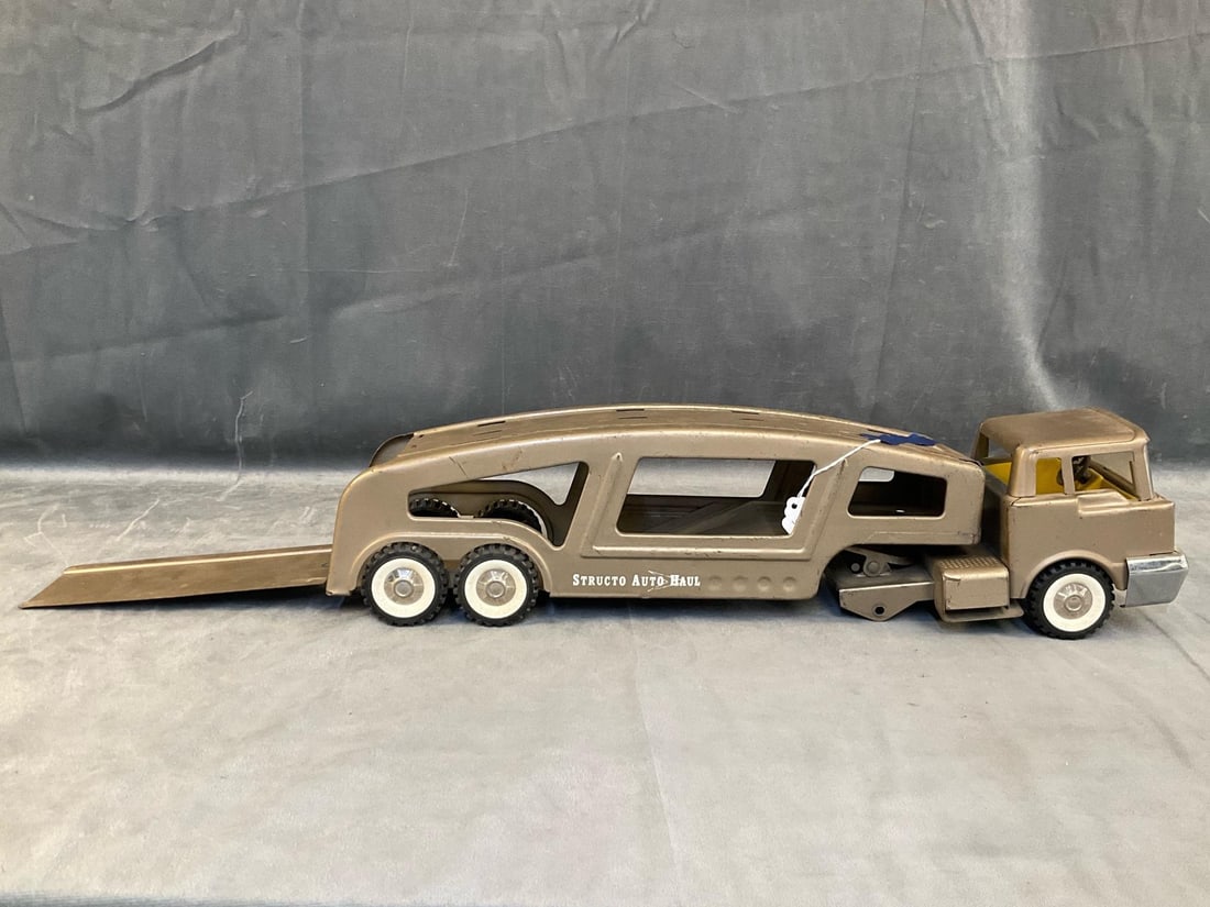 Metal Toy Truck: Vintage 1960's Structo Auto Haul carrier toy metal truck. Missing back truck axle and tires. Measures 22 inches wide x 5.25 x 5 inches tall.