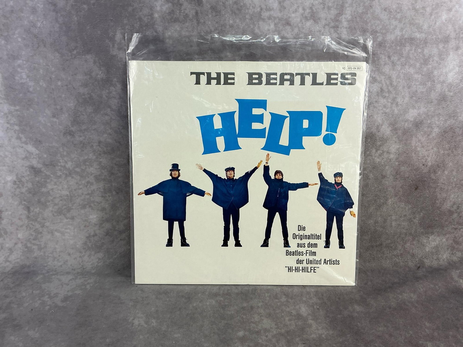 The Beatles Vinyl: Rare 1977 German pressing of The Beatles album "Help". In good condition with original sleeve. Measures 12.25 inches wide x 12.25 inches tall.