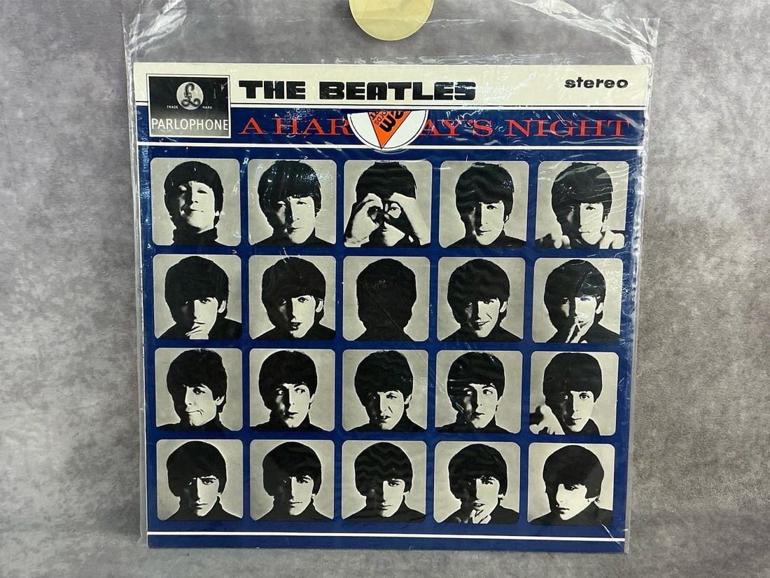 The Beatles Vinyl: 1964 The Beatles "A Hard Days Night" vinyl record. The album contains the soundtrack from their film of the same name. In good condition with original sleeve. Measures 12.25 inches wide x 12.25