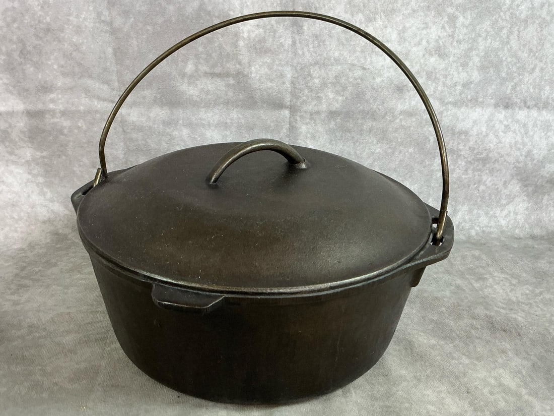 Cast Iron Dutch Oven: Mid 1900's cast iron Dutch oven with drip-drop lid. Number 8 pot has metal handle. In good condition. Measures 10.25 inches in diameter x 4 inches tall.