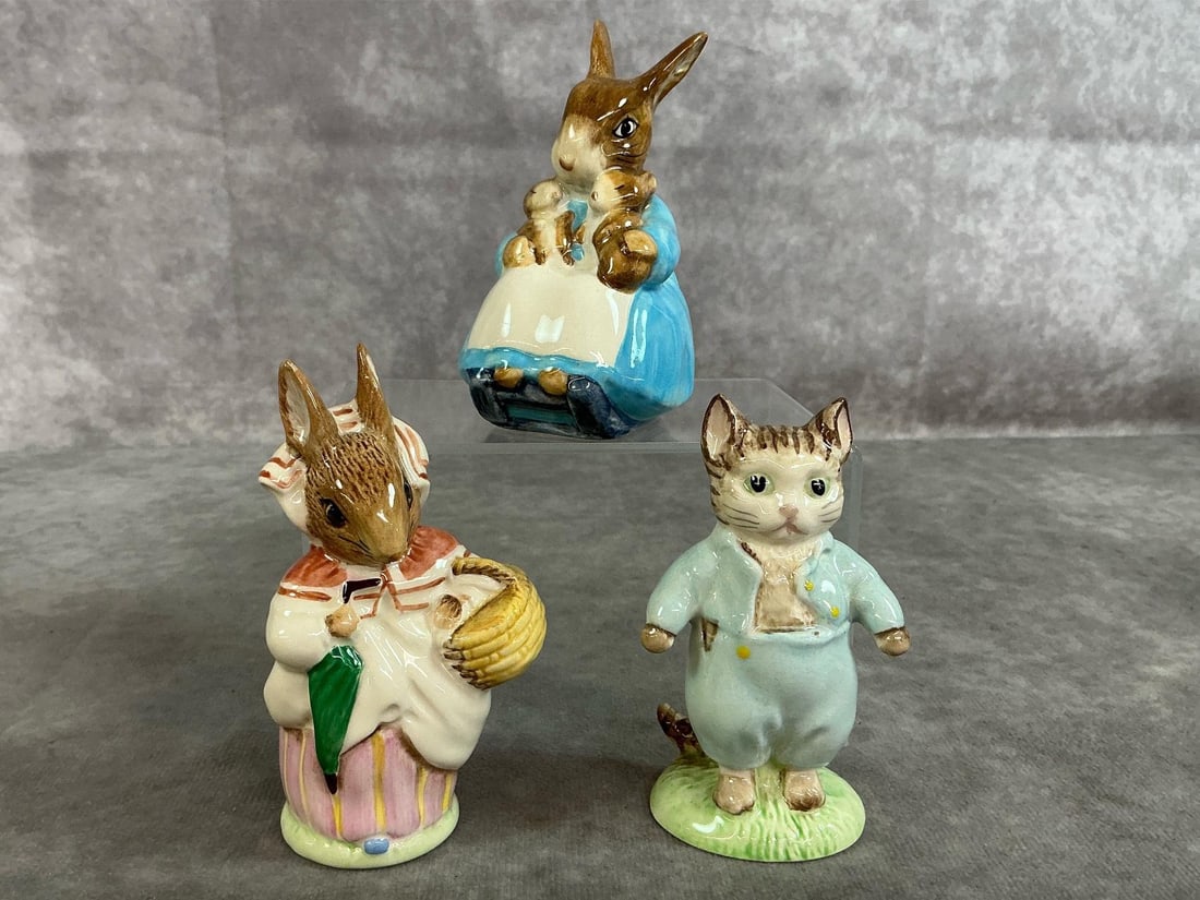 Beatrix Potters Figures: Three mid 1900's Beatrix Potter collectibles. Includes 1948 Tom Kitten, 1951 Mrs Rabbit, and 1976 Mrs Rabbit and Bunnies. In good condition. Mrs Rabbit with Bunnies measures 2 inches wide x 2 x 3.75