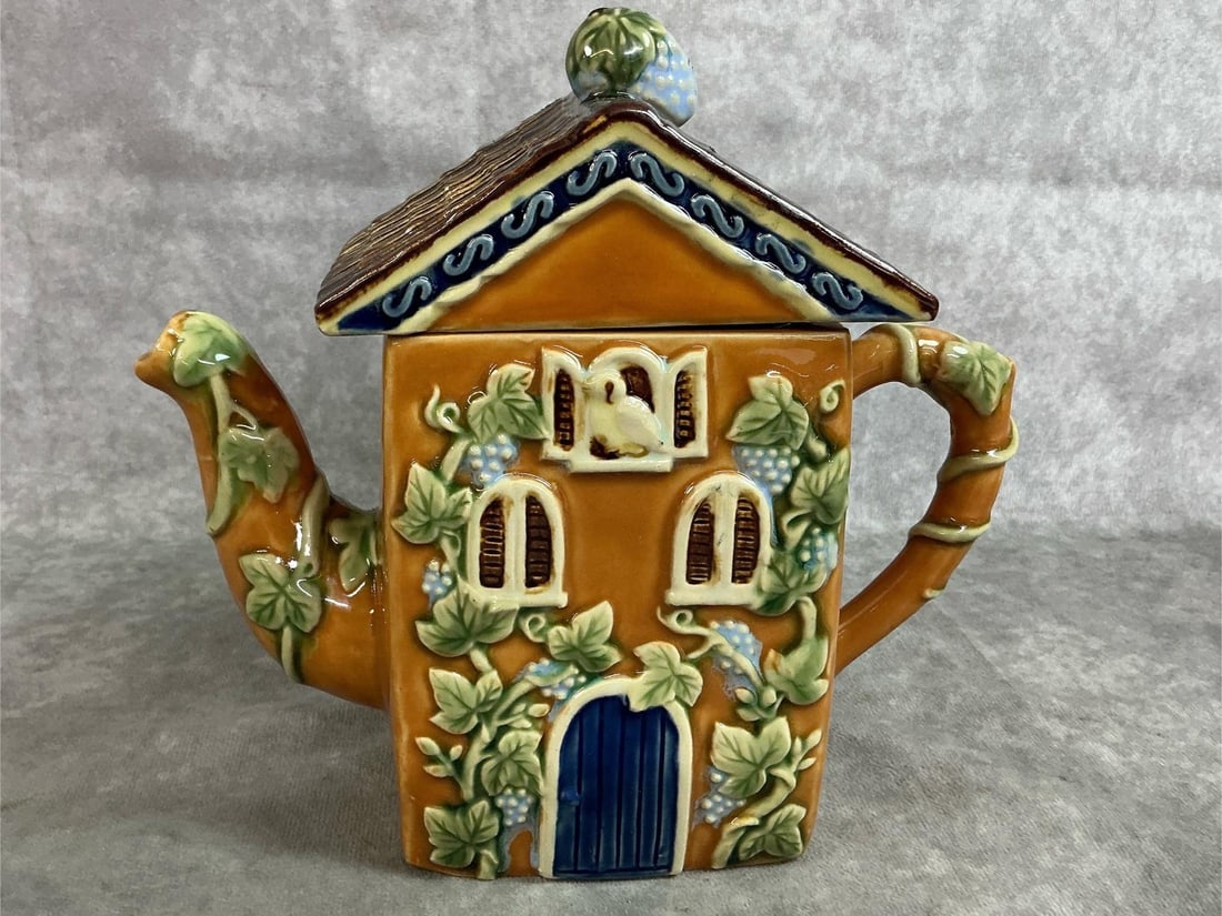 CBK Nouveau Majolica House Teapot: 1991 CBK Ltd Nouveau Majolica glazed ceramic cottage teapot made in Wanjiang, China, featuring a pitched roof lid and embossed botanical motifs. Fair condition with an inner rim lid chip, otherwise