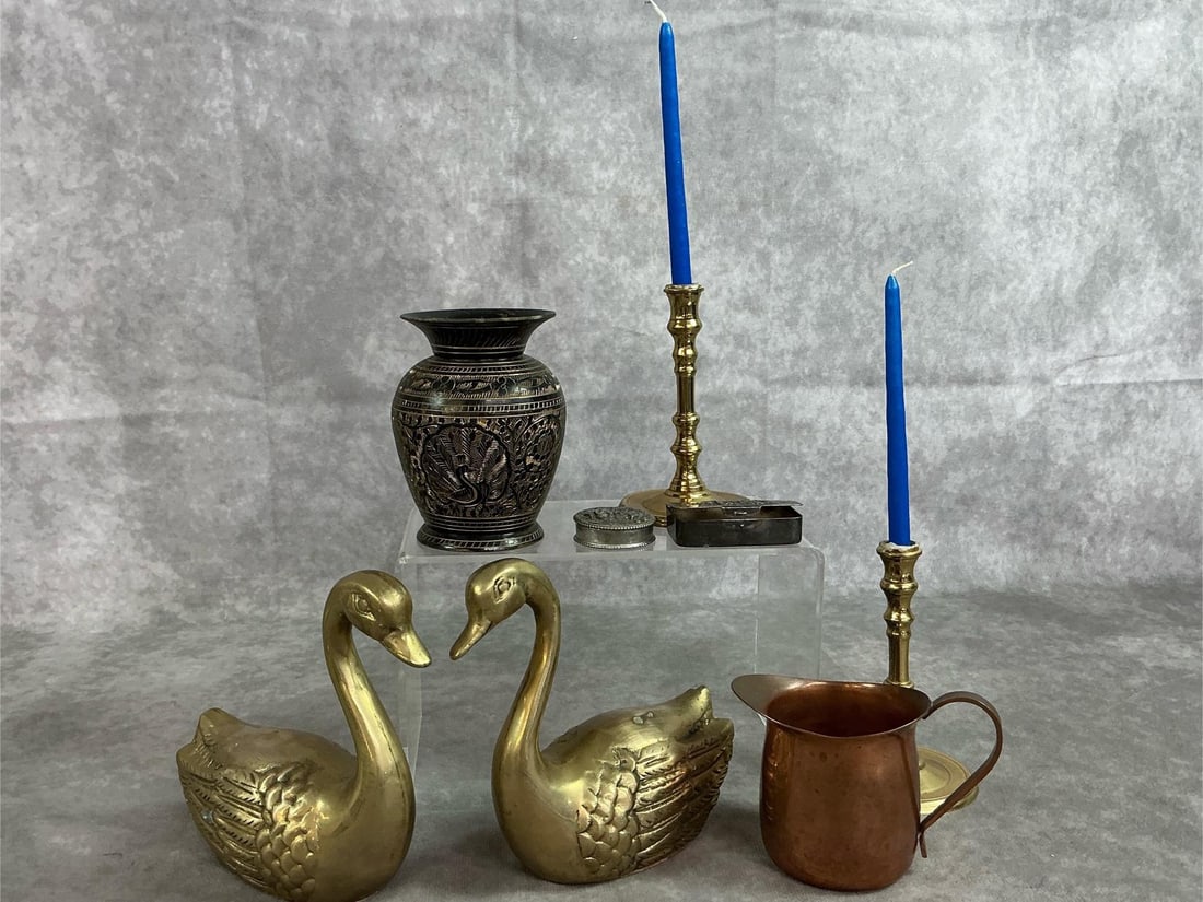 Brass & Copper Collectibles: Eight mid 1900's items. Two brass swans with etched feathers, brass vase with black and gold Bohemian vase from India, and two brass mini candle holders. Also, copper creamer and two metal pill boxes.