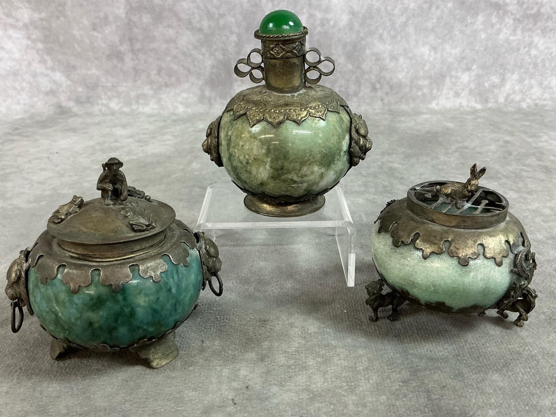 Chinese Incense Burners: Three early 1900's Chinese incense burners. Green hardstone (possibly Jade) with white metal bases, lids and motifs. Decorations include metal lions, monkeys, and rabbit. Tarnish present and a break i