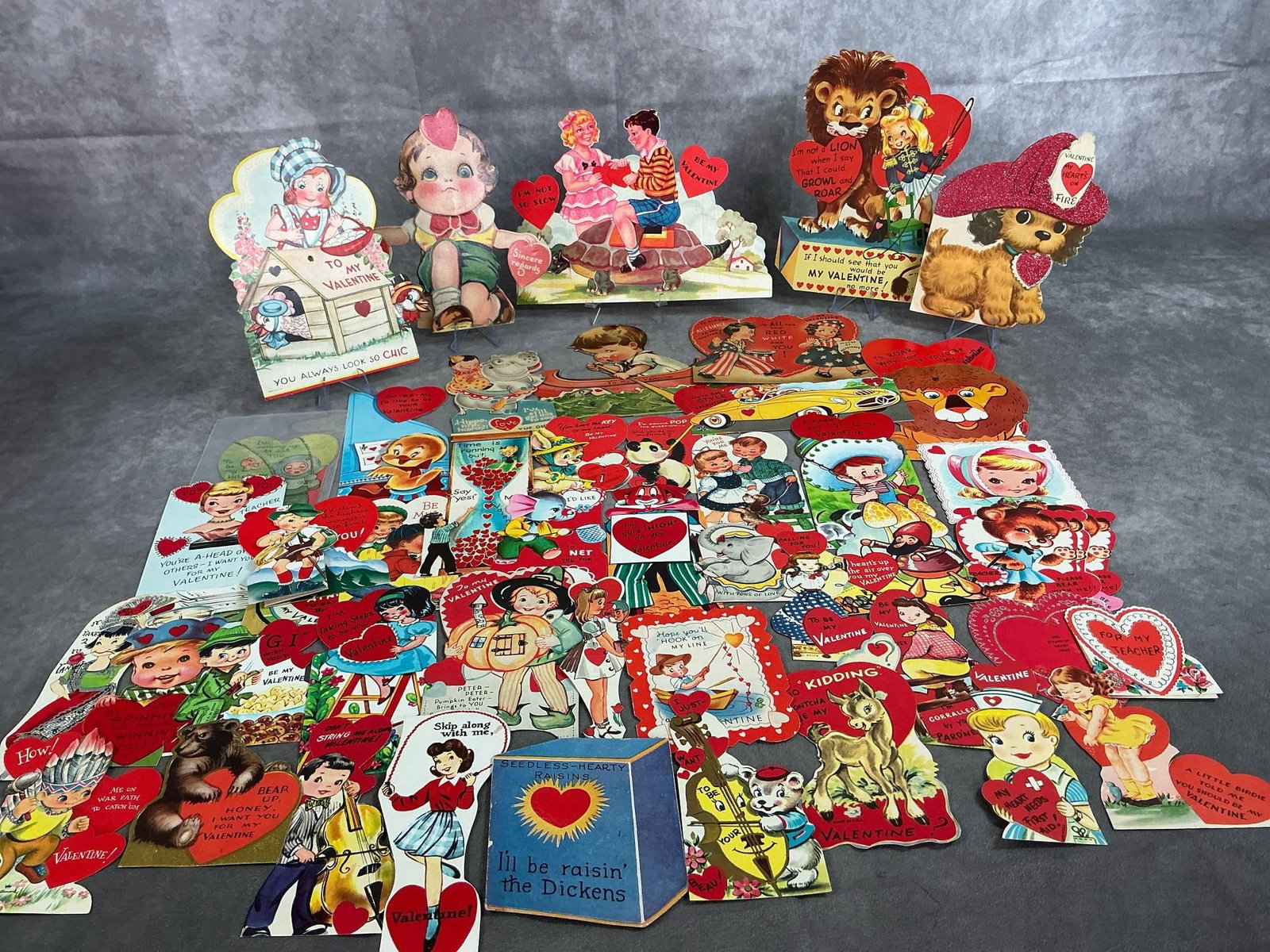 Collection of Valentines: Around fifty 1920's - 1950's children's valentines. Some are marked on back, otherwise in good condition. Largest measures 8 inches wide x 6 inches tall.