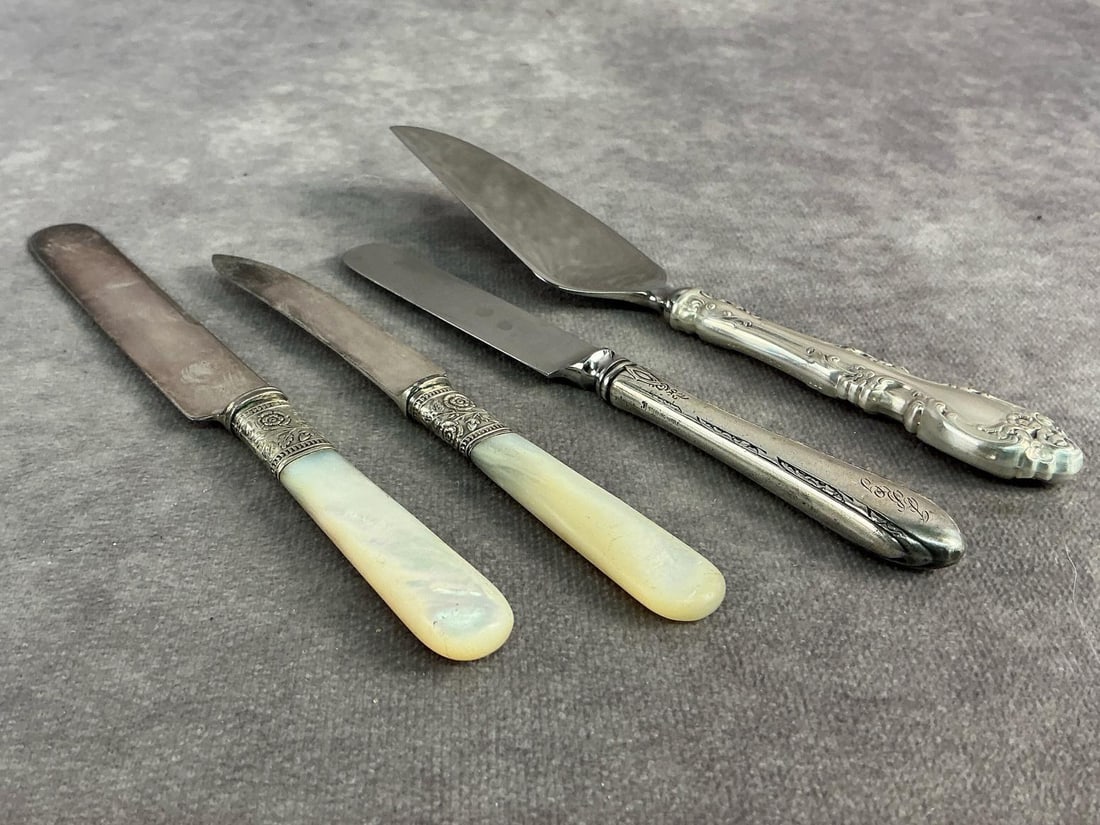 Sterling Handles & Trim: Four Sterling silver handled and trimmed utensils. All in good condition, stamped with oxidation present. Total weight 4.54 ozt.