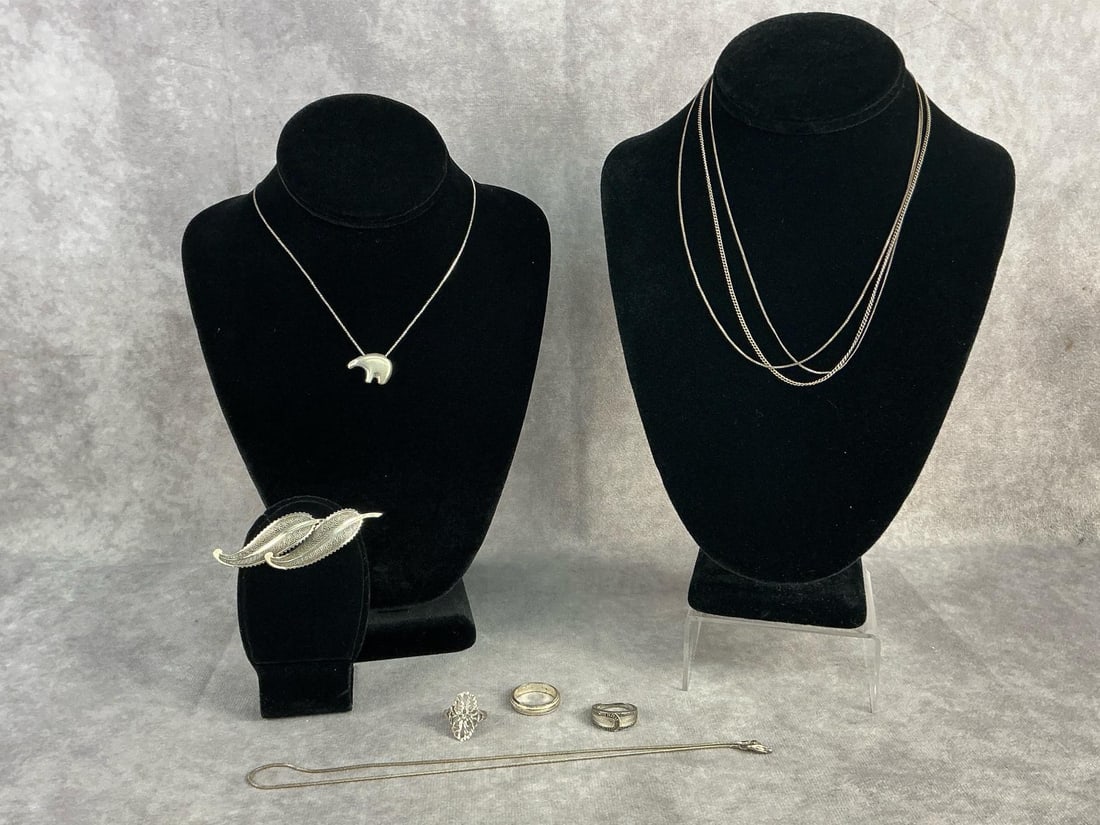 Sterling Silver Jewelry: Sterling silver jewelry including five chains, one having a pendant, one brooch, and three rings. All in good condition, stamped with oxidation present, although one clasp is broken. Total weight