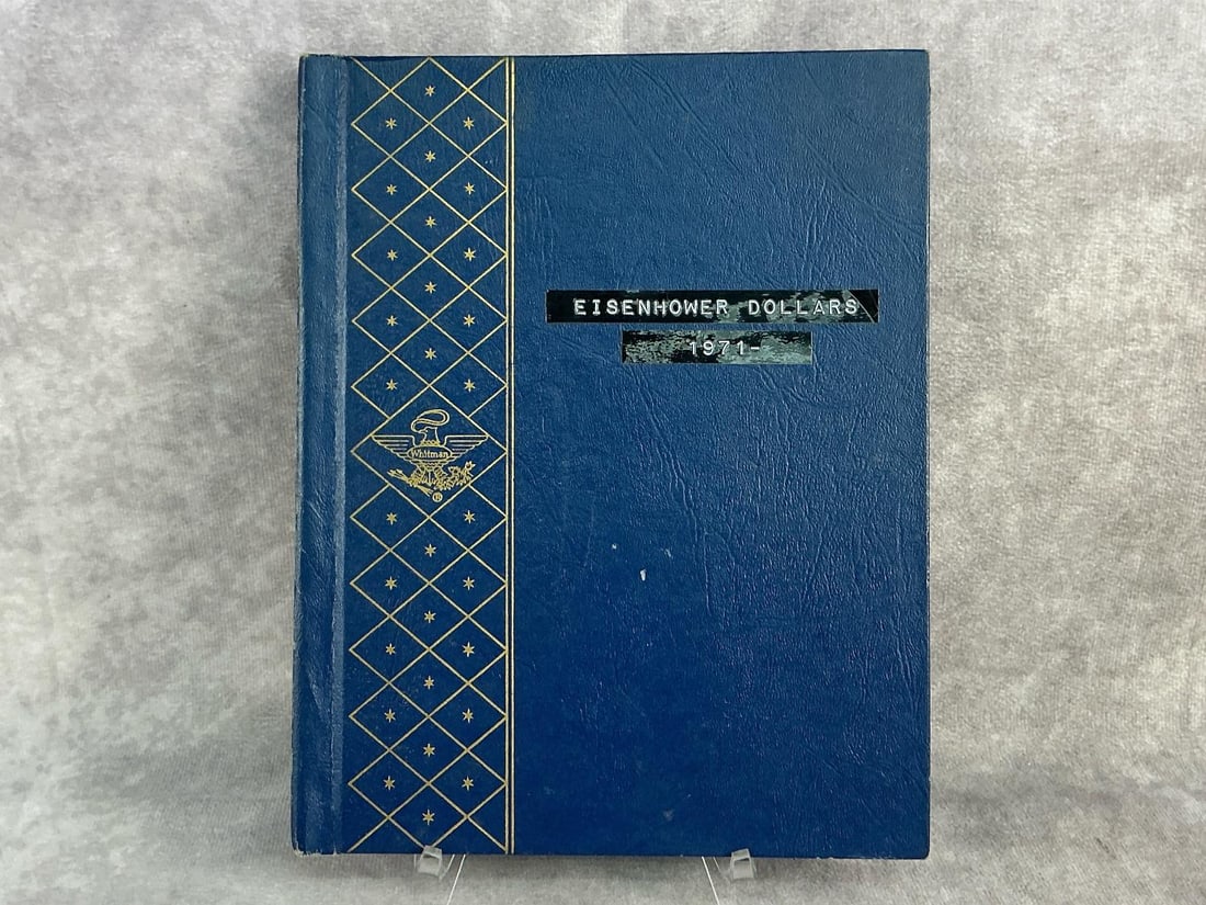 Eisenhower Dollars: Twenty four 1971 Eisenhower Dollar Coins. In good circulated condition and stored in Whitman coin book. Book measures 7 inches wide x 8.75 inches tall.