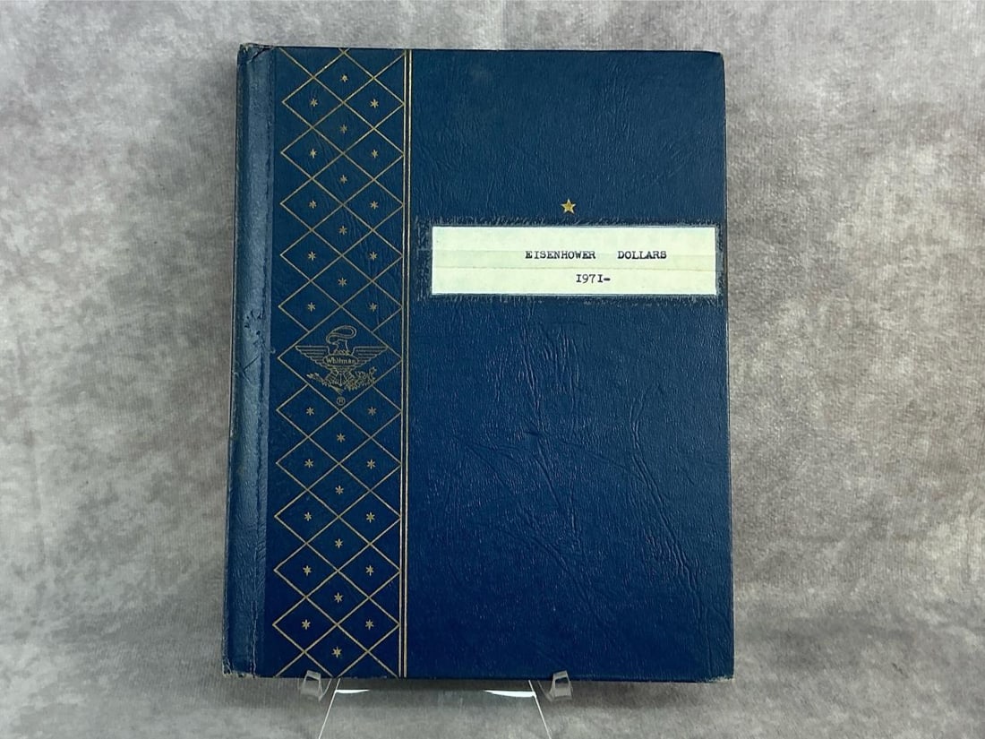Eisenhower Dollars: Twenty four 1971 P Eisenhower Dollar Coins. In good circulated condition and stored in Whitman coin book. Book measures 7 inches wide x 8.75 inches tall.