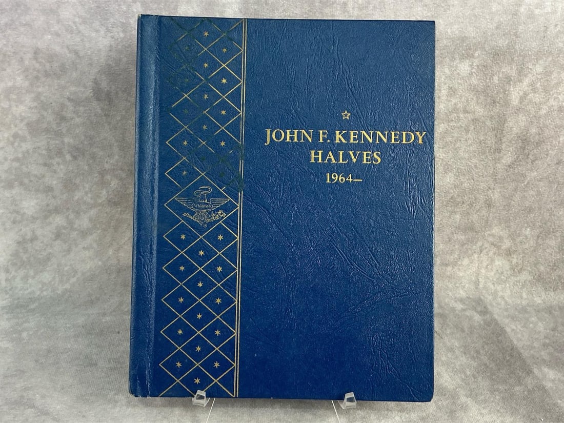 Kennedy Halves: Thirty two John F. Kennedy Half Dollars. In good circulated condition and stored in Whitman coin book. Book measures 7 inches wide x 8.75 inches tall.