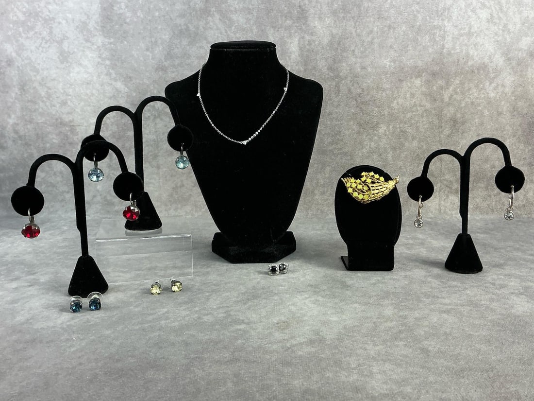 Sterling, Sabika, & Uranium Jewelry: Sterling silver necklace and pair of earrings, four earring pairs from Sabika, and uranium brooch. All in good condition. Total weight for sterling is .165 ozt.