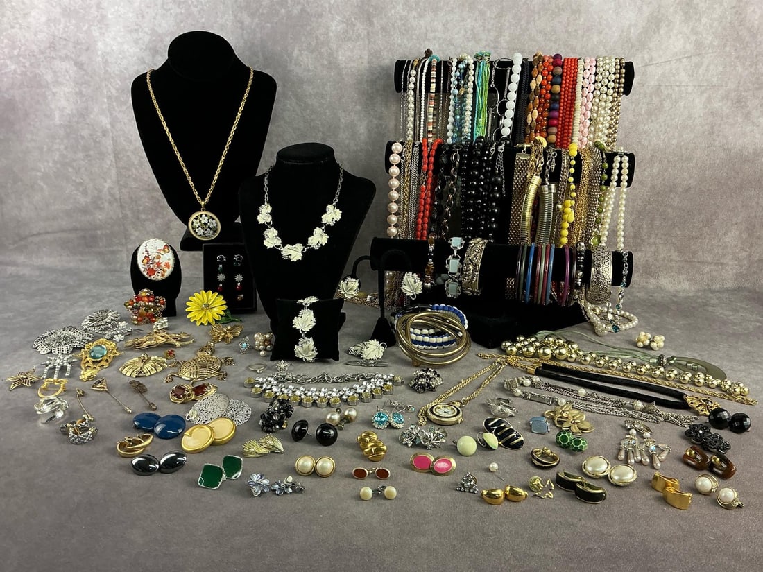 Costume Jewelry: Approximately 100 plus pieces of costume jewelry including necklaces, bracelets, earrings, brooches and more. All in good condition with brands such as Sarah Coventry, Monet, Avon, etc. Longest chain 