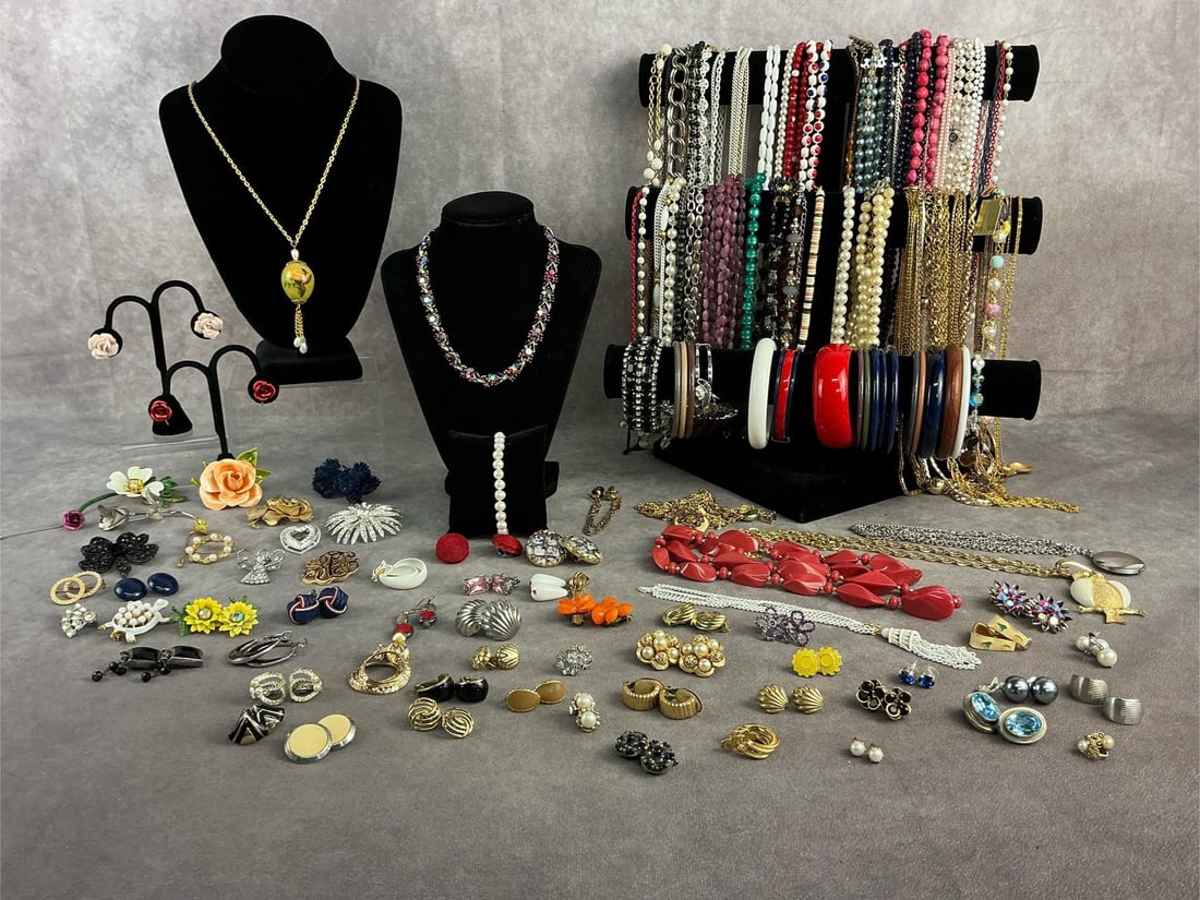 Costume Jewelry: Approximately 100 plus pieces of costume jewelry including necklaces, bracelets, earrings, brooches and more. All in good condition with brands such as Sarah Coventry, Monet, Avon, etc. Longest chain 