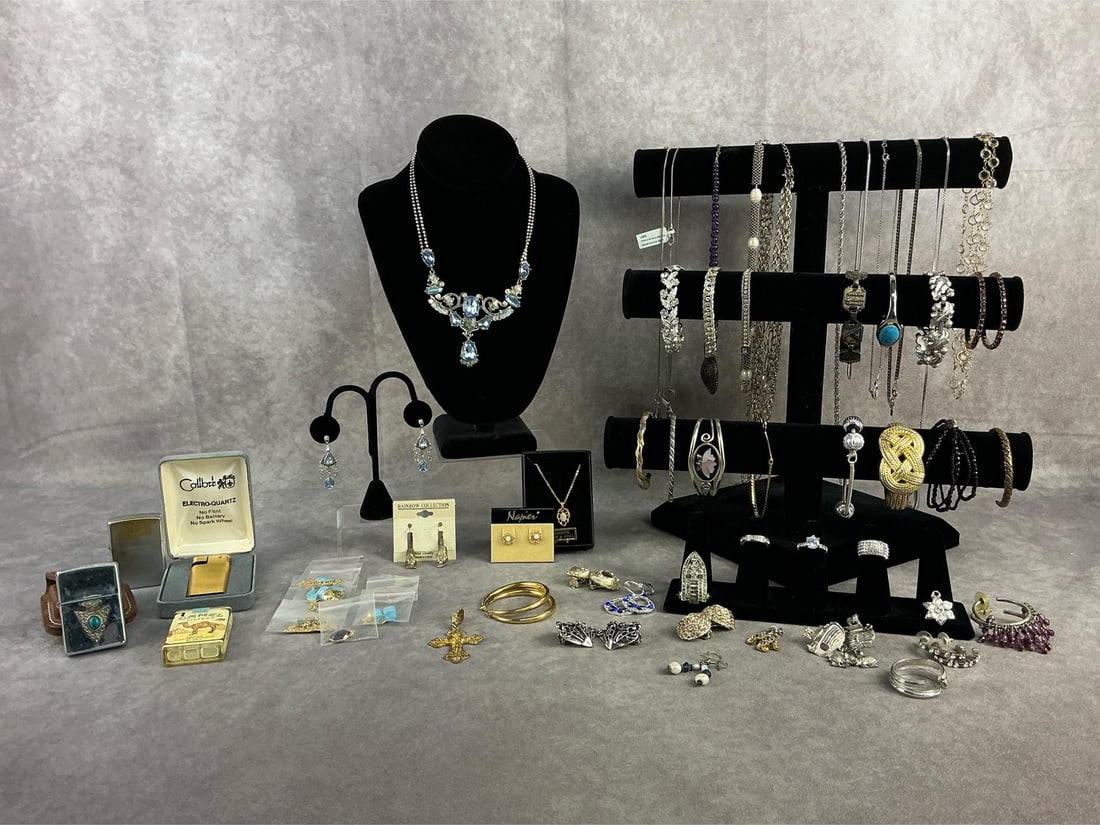 Costume Jewelry: Costume jewelry including approximately thirteen necklaces, sixteen bracelets, three rings, fourteen earring pairs, lighters and more. All in good condition. Longest chain measures 16 inches closed.