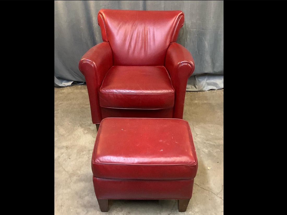 Leather Club Chair: Contemporary red leather club chair and footstool. Scratches to back and sides, otherwise good condition. Measures 33.5 inches wide x 32 x 35 inches tall.
