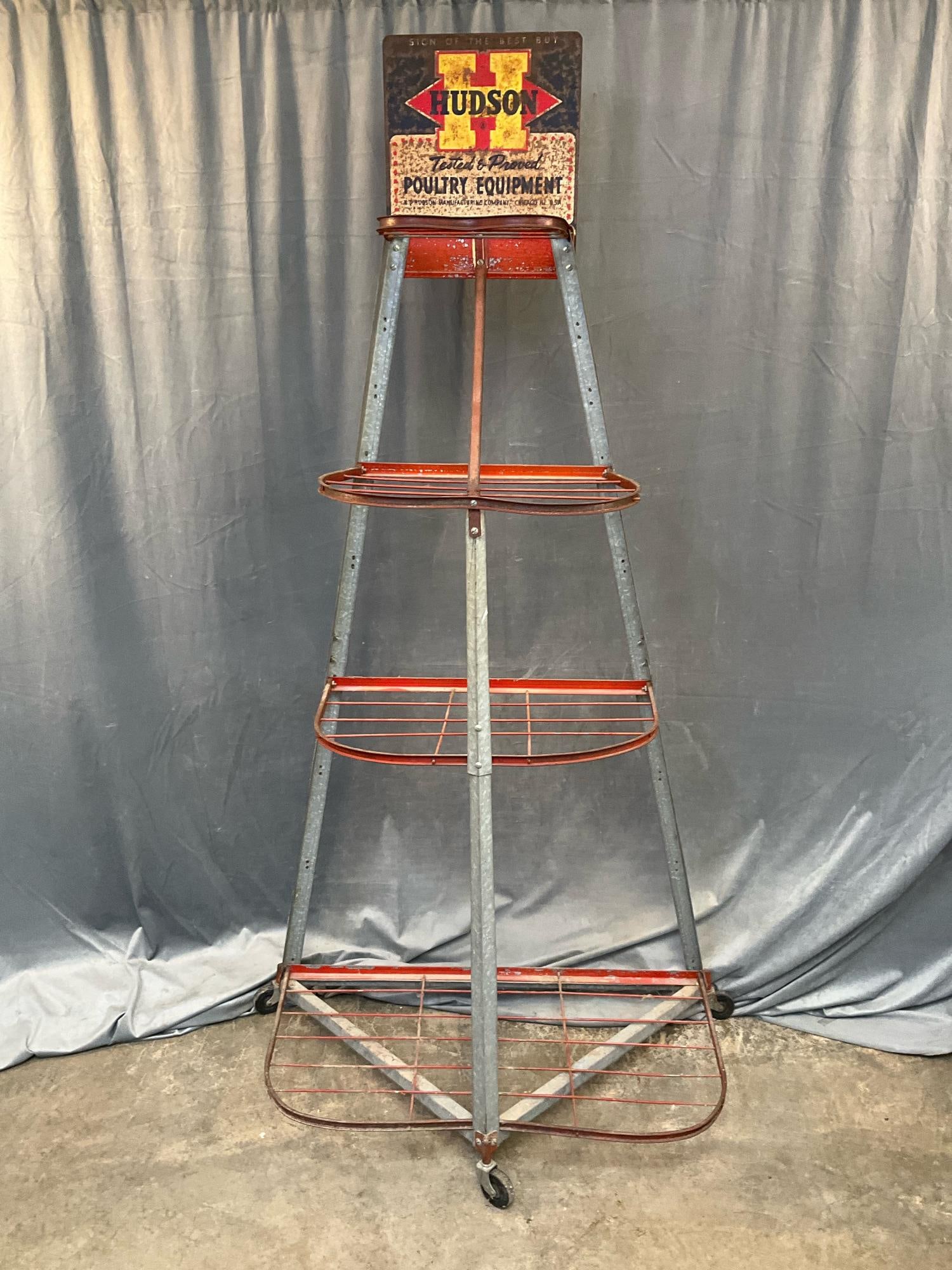 Poultry Ad Rack: Vintage mid-20th century Hudson Poultry advertising metal four shelf display rack on castors. Surface rust, otherwise good condition. Measures 37 inches wide x 19 x 77 inches tall.