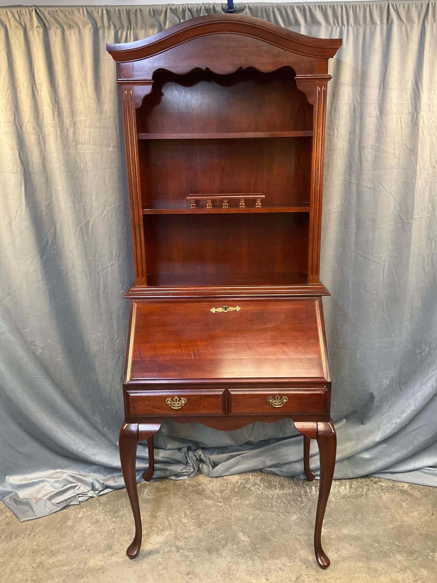 Secretary Desk: Contemporary reproduction Singer Furniture Company Queen Anne Style slant front secretary bookcase with cabriole legs and pad feet. Drawer missing runners does not open properly, otherwise good