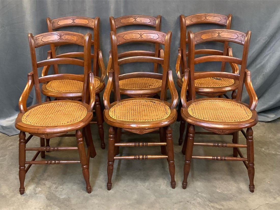 Set of Victorian Chairs: Set of six late 19th century walnut side chairs with cane seats. All seats reinforced with wood, three seats with damaged cane bottoms, one chair rung loose and one back support missing screw, otherwi