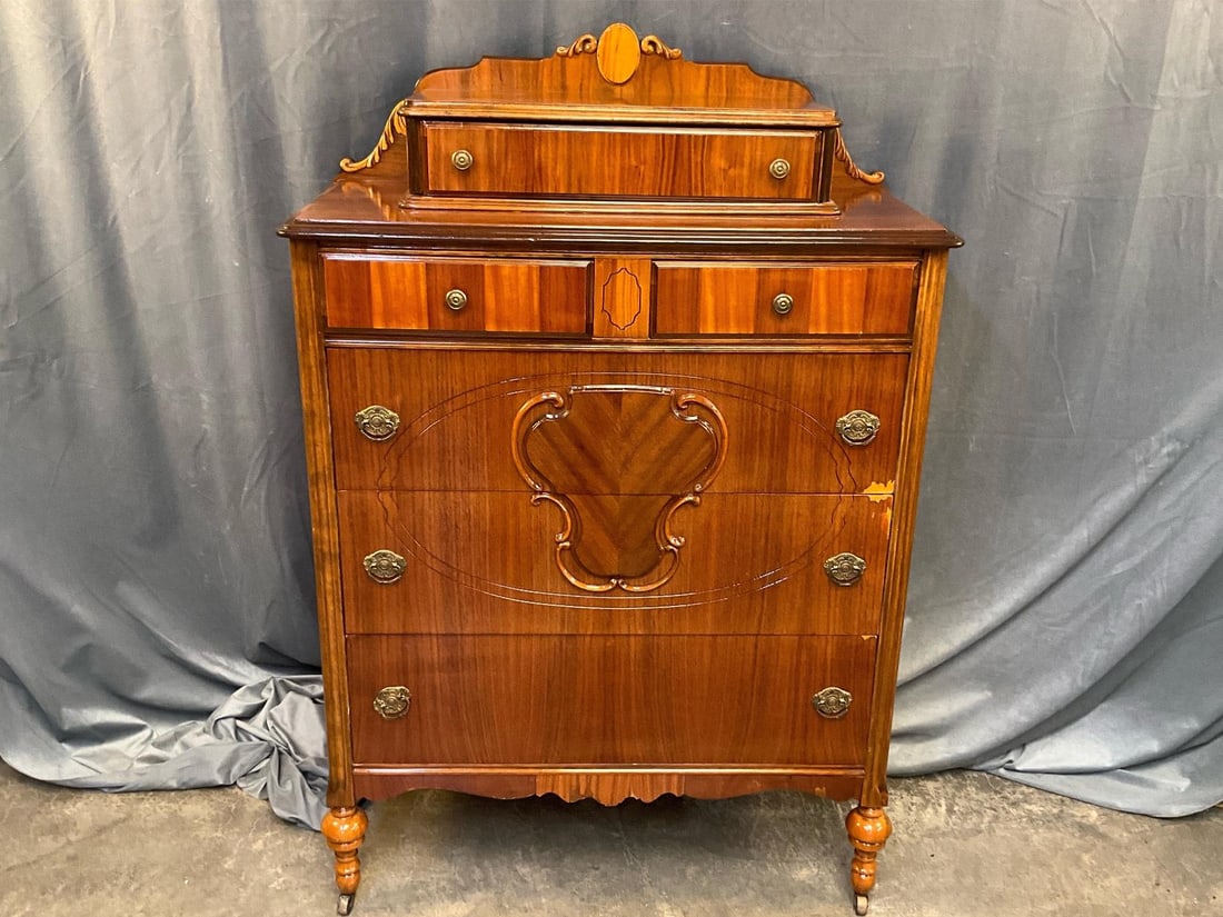Chest of Drawers: Early 20th century chest of drawers/dresser with mahogany veneer. Areas of veneer loss, otherwise good condition. Measures 34.5 inches wide x 17.5 x 54 inches tall.