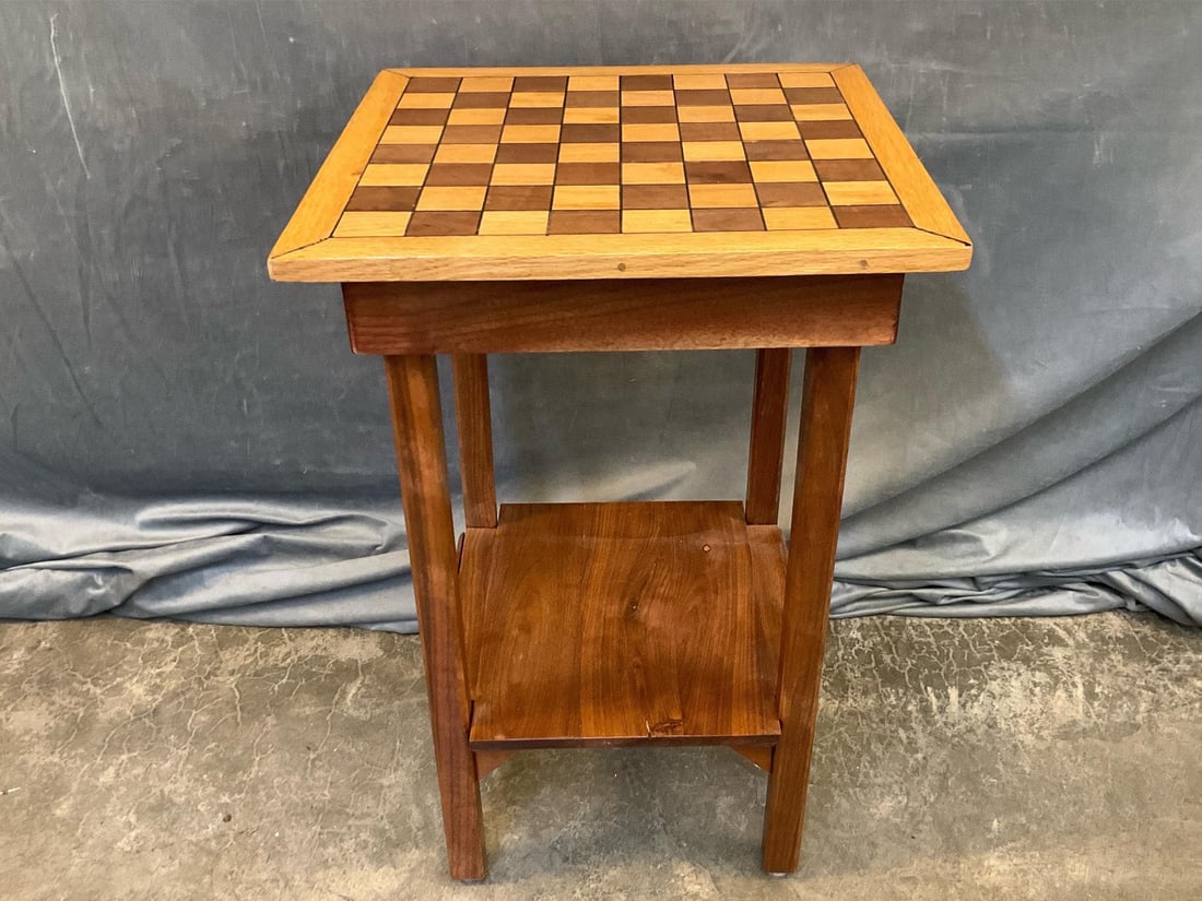 Game Board Table: Contemporary walnut and oak game checker/chess table with lower shelf. Signed on bottom with illegible initials, date of 2000 and Willis, Virginia. Good condition. Measures 19.5 inches wide x 19 x