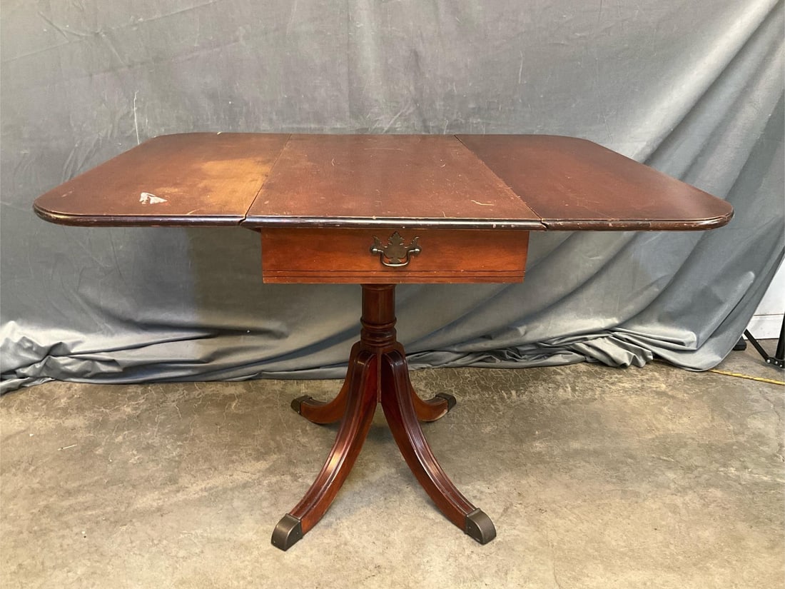 Drop Leaf Table: Mid-20th century mahogany Duncan Phyfe Style one drawer drop leaf table. Scratches to finish otherwise good condition. Measures 35.5 inches wide x 17.5 x 28.25 inches tall. Leaves extended measures 43