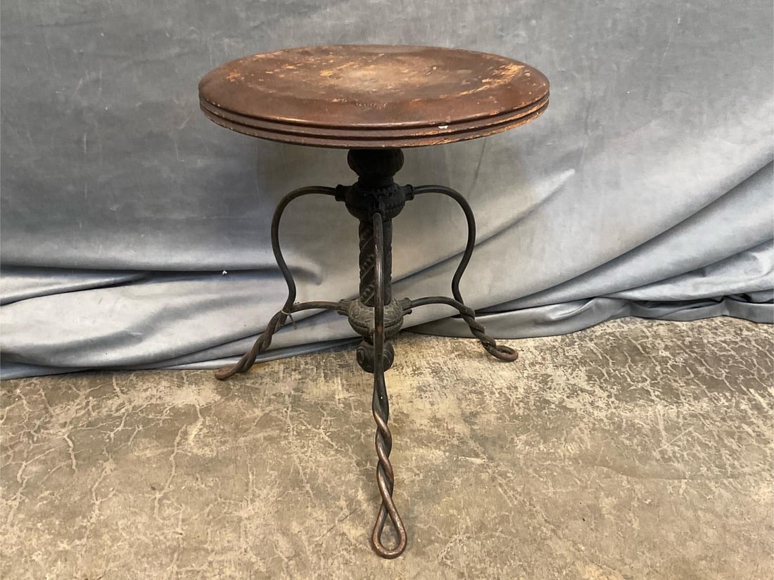 Tonk Piano Stool: 1880-1908 Max Tonk Manufacturing Company of New York and Chicago piano stool with ornamental cast iron base, wire feet and oak seat. Good condition. Measures 14.5 inches in diameter x 18.25 inches tal