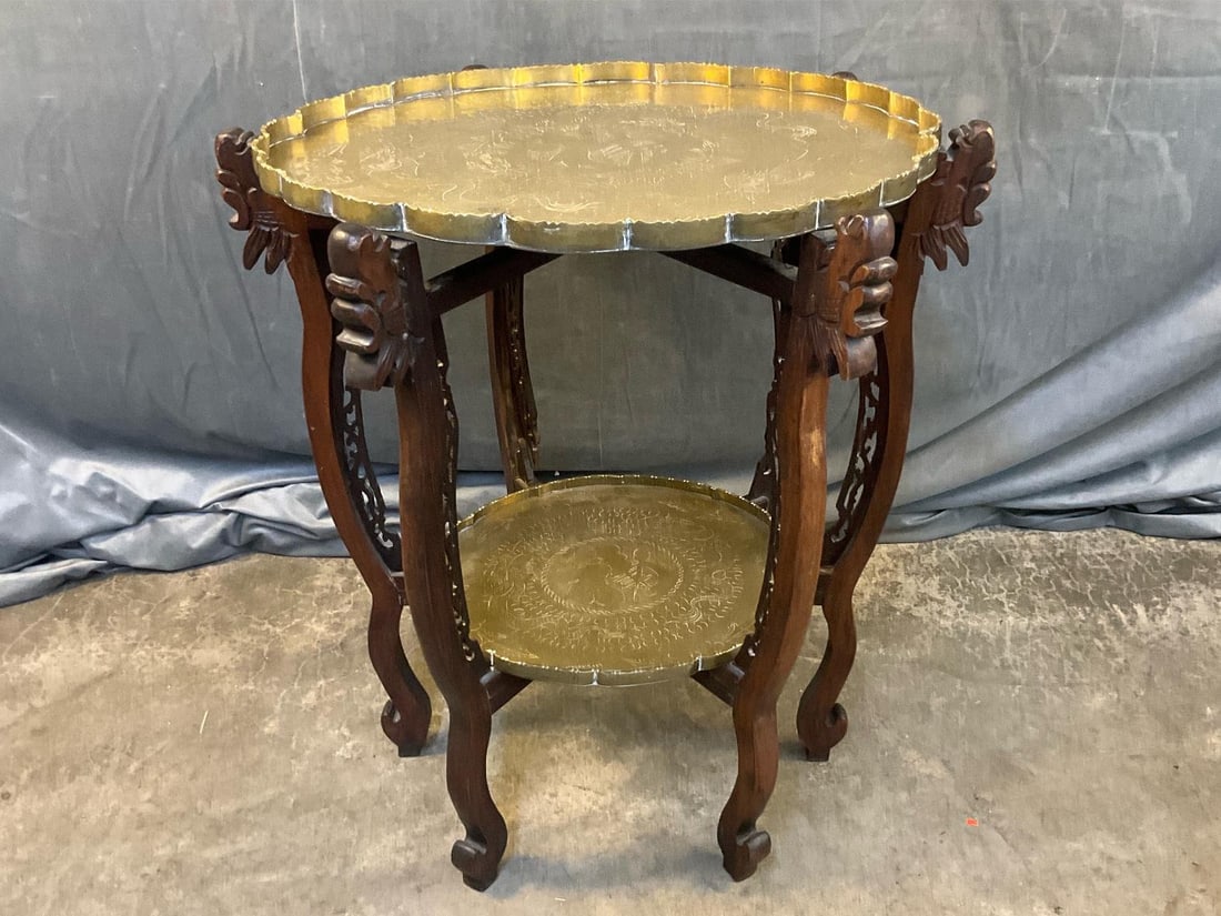 Chinese Brass Table: Early-mid 20th century folding brass engraved two tier Chinese table. Marked with Chinese characters on bottom of top tray. Replacement screws to wooden stand, rim separated on brass top and damaged