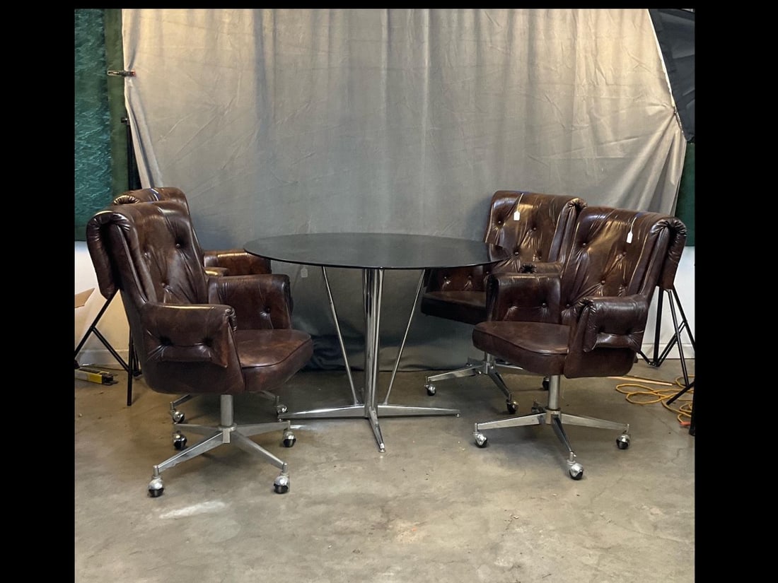 MCM Table /Chairs: Mid-20 century set of four vinyl and stainless steel chairs and table with glass removable top. Good condition. Table without glass top measures 28.5 inches in diameter x 29 inches tall.