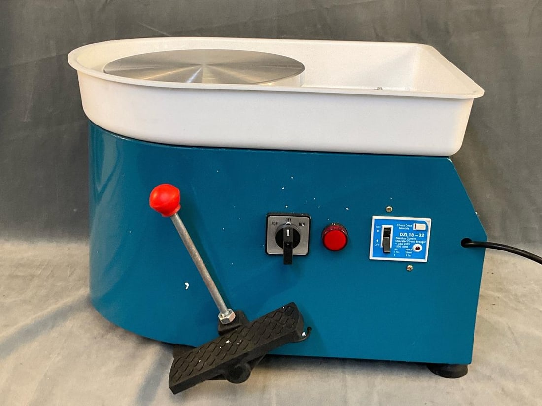 Pottery Wheel: Contemporary pottery throw wheel DZL18-32 with residual current operational circuit breaker. Includes assorted pottery tool set. Good used condition. Tested powers on and wheel turns. Measures 19