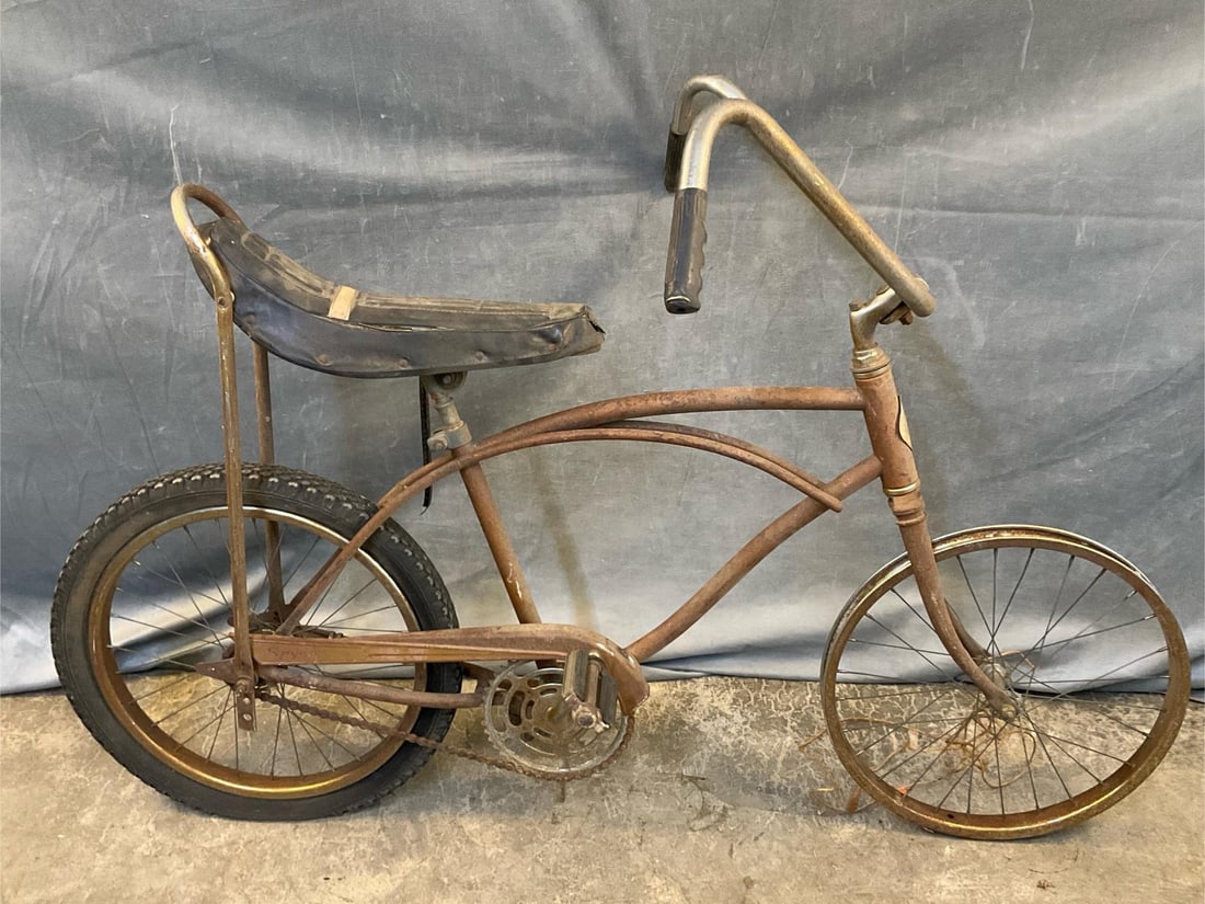Child's Muscle Bike: Circa 1967 vintage Sears child's bicycle with high bars and banana seat. Overall rust, torn seat and missing front tire. Measures 55 inches wide x 29 x 36 inches tall.