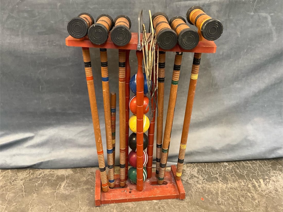 Croquet Set: Vintage 1960's wooden croquet set with six mallets, two stakes, hoops and six balls with stand. Used condition, otherwise good condition. Measures 17 inches wide x 7.25 x 26 inches tall.