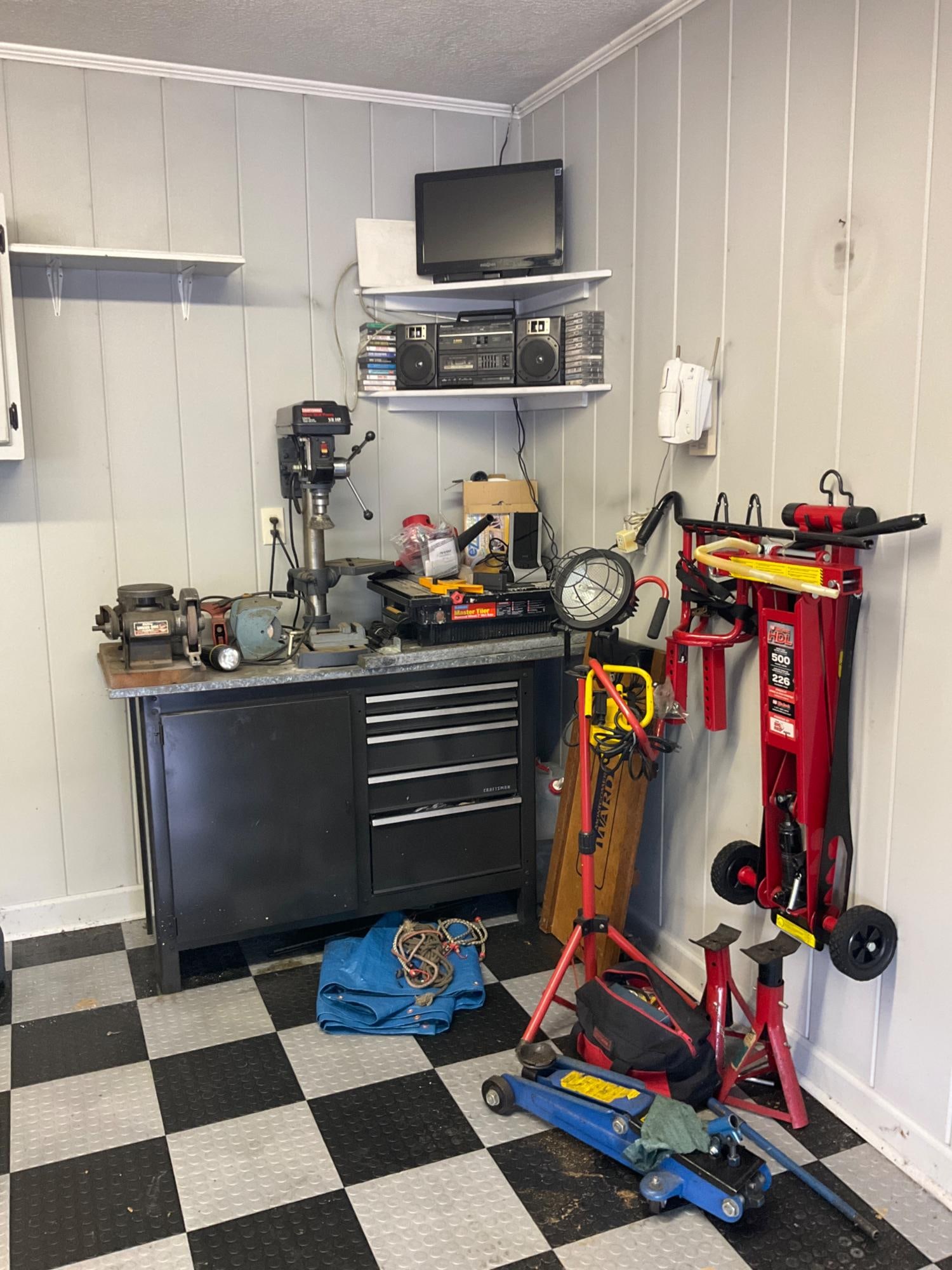 Assorted Tools: Includes: storage chest/table/bench including contents, jacks, lifts, lights, creeper, drill press, grinder, master tiler, cassette player, tapes, cd's, t.v., plus more. Good used condition, not