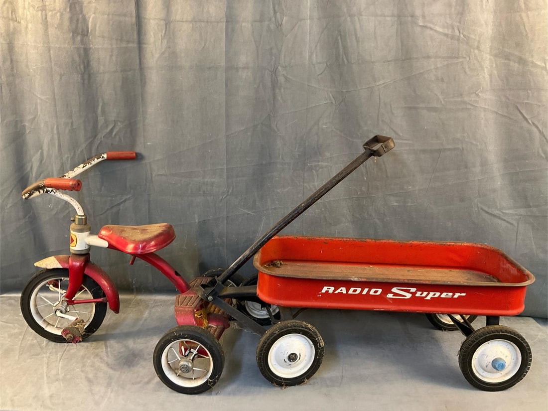Vintage Tricycle/Wagon: 1960's Radio Super metal wagon and Western Flyer tricycle. Used condition with areas of rust, tricycle front tire damaged with holes. Wagon measures 33 inches wide x 13.25 x 11.5 inches tall not