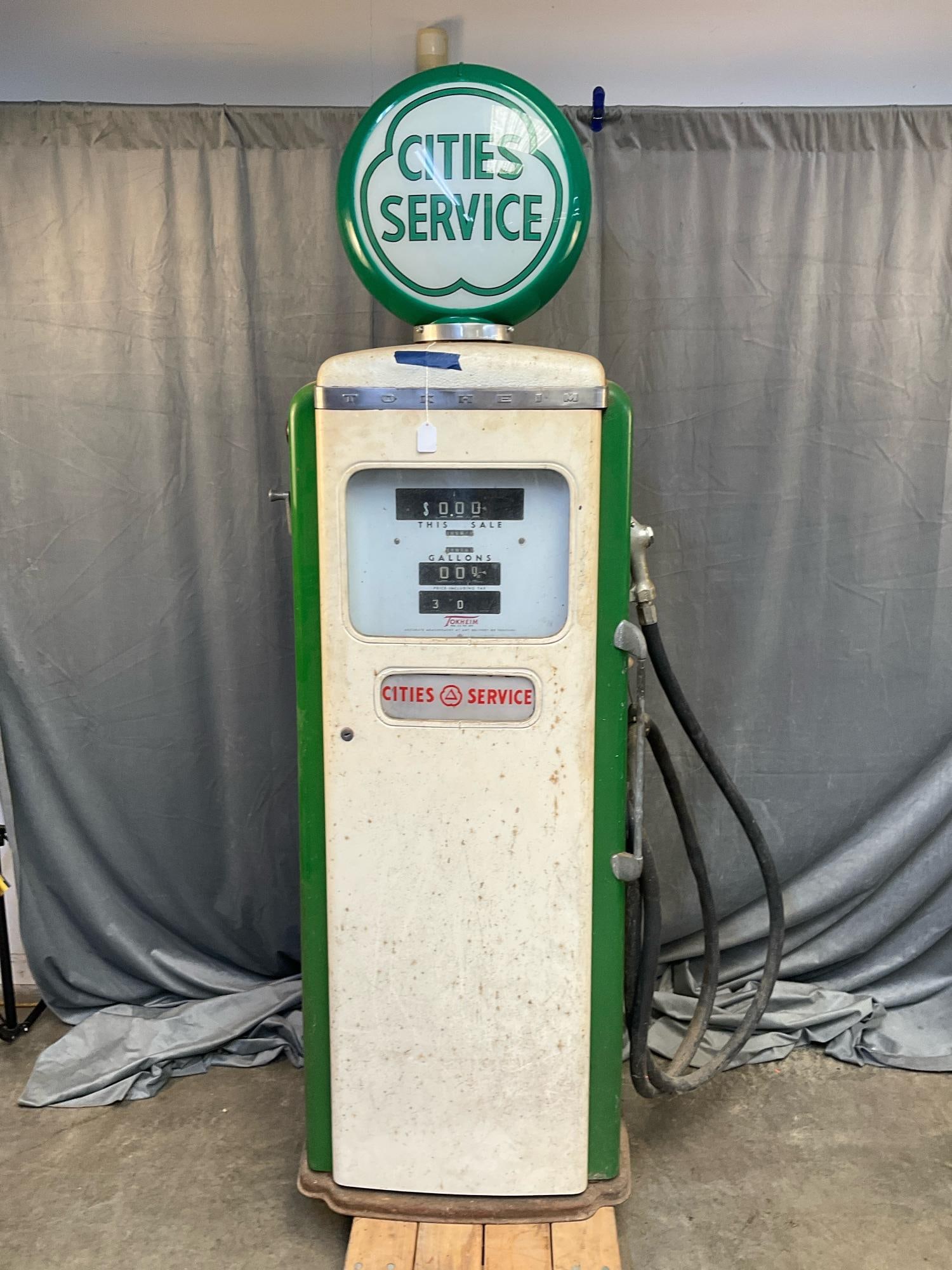 Cities Service Gas Pump: 1950's Cities Service Tokheim Model 300 Type P electric gasoline pump with original paint and working lighted plastic globe. Missing original glass globe, areas of rust and abrasion. Measures 24 inche