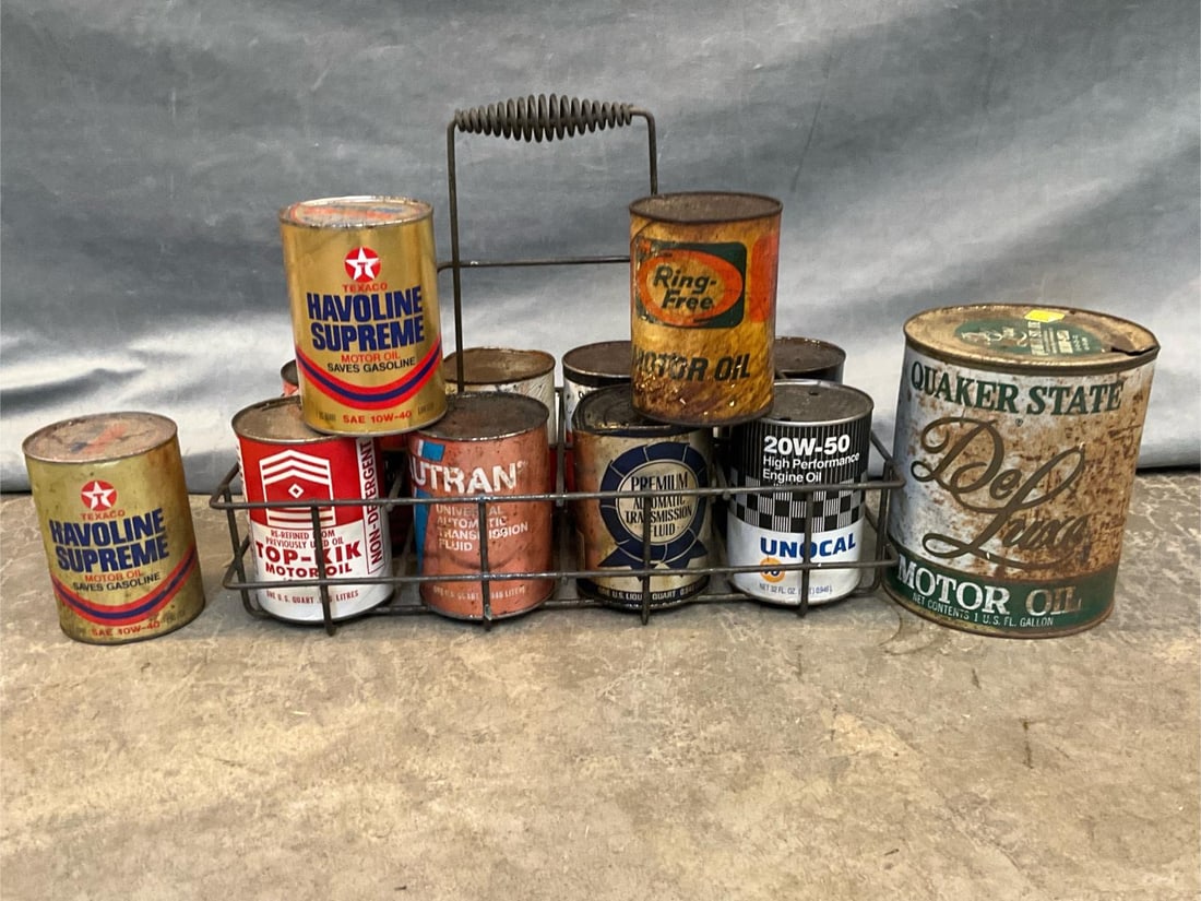 Motor Oil Cans: Twelve late 20th century vintage oil cans and wire carrier. Including; Exxon, Quaker State, Havoline, Harley Davidson, Top-Kik plus more. Used condition. Carrier measures 19 inches wide x 1 x 14 inche