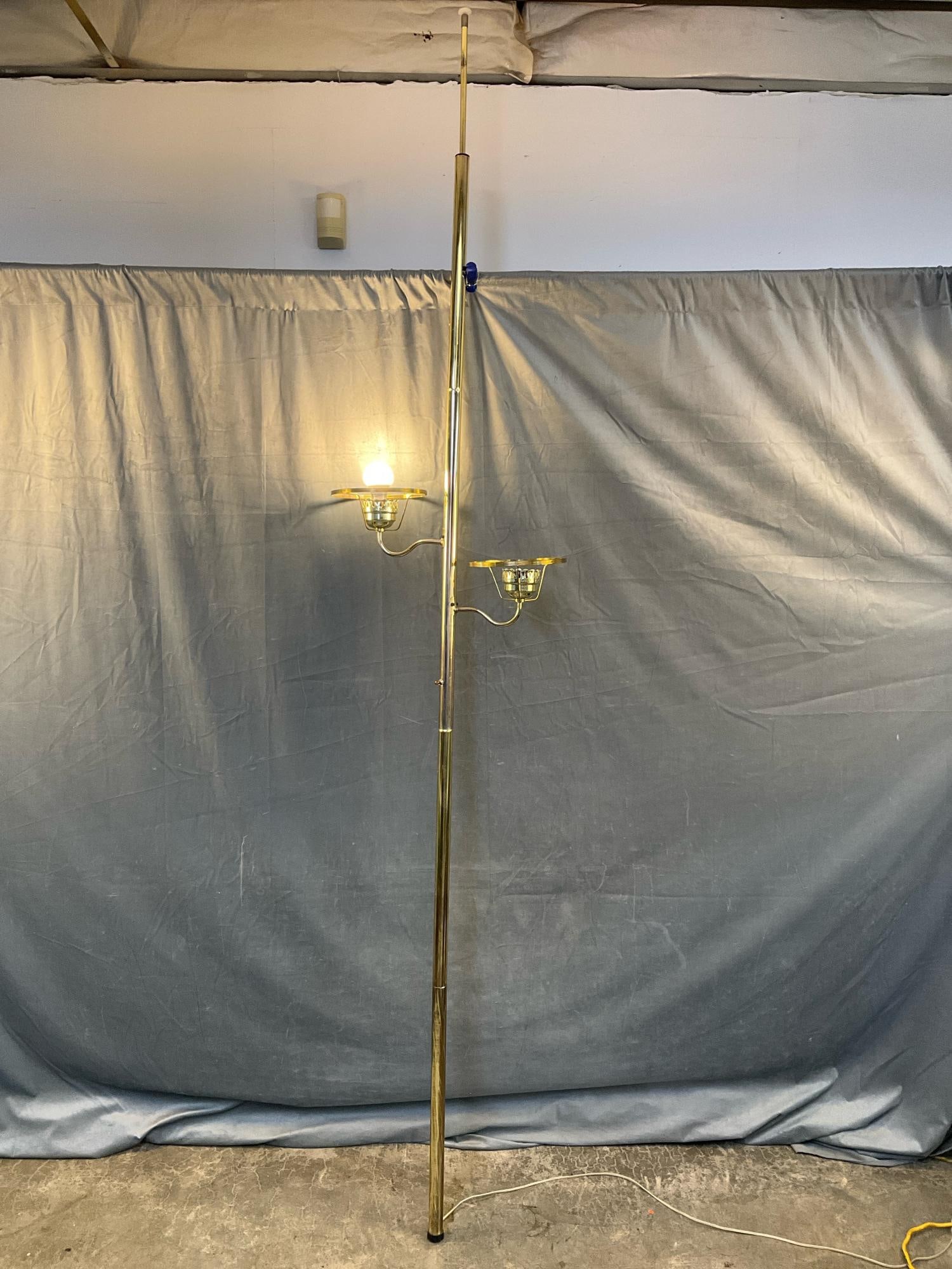 MCM Floor Lamp: 1960's brass two light adjustable tension floor lamp. Good condition, tested works. Measures 21 inches wide x 8.25 x 103 inches tall.