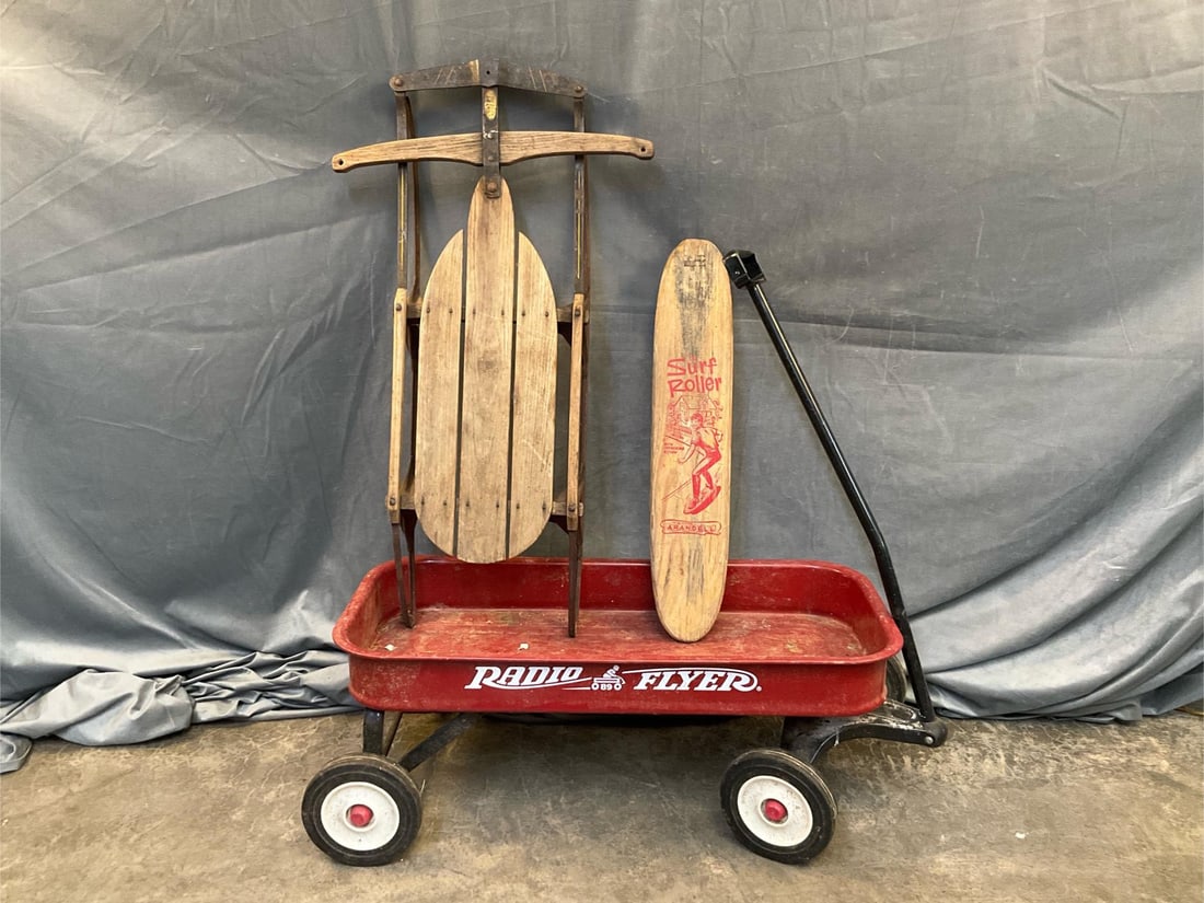 Outdoor Toys: Three outdoor 1960's - 1970's vintage children's toys. Surf Roller Arandell skate board. Used condition with rust and wear. Sled. Used condition, weathered with surface rust. Radio Flyer 89 red wagon.