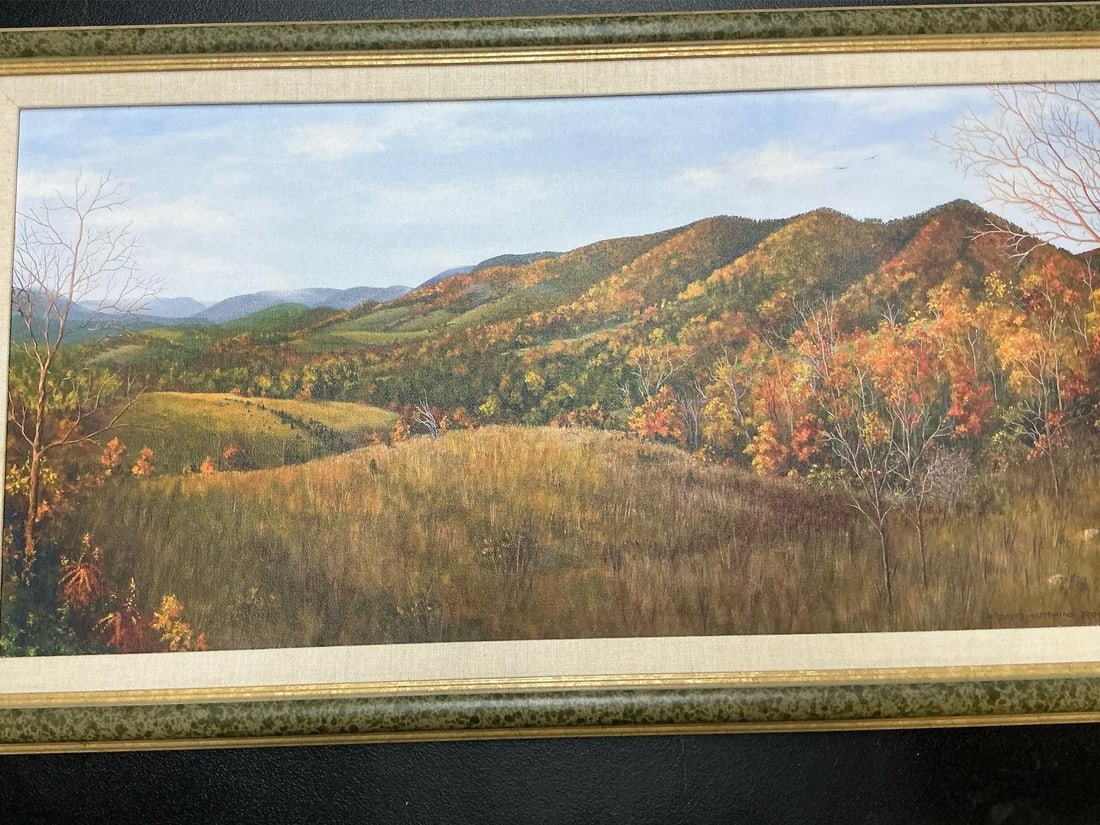 Autumn Mountains: 2005 reproduction of oil painting by David Hutchins. Fall mountainside framed in green speckled and gold frame. In good condition. Measures 31.5 inches wide x 1.5 x 18 inches tall.