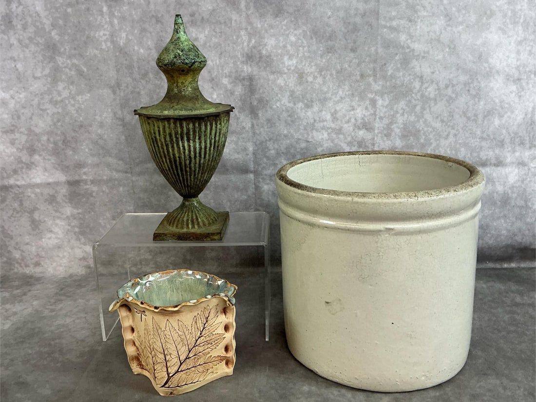 Crock, Pottery Vase & Metal Urn: Three mid to late 1900's items. Two gallon crock, cast metal lidded urn, and clay pottery vase with leather-look and leaves print. Crock has a crack on one side and on bottom edge, urn has patina