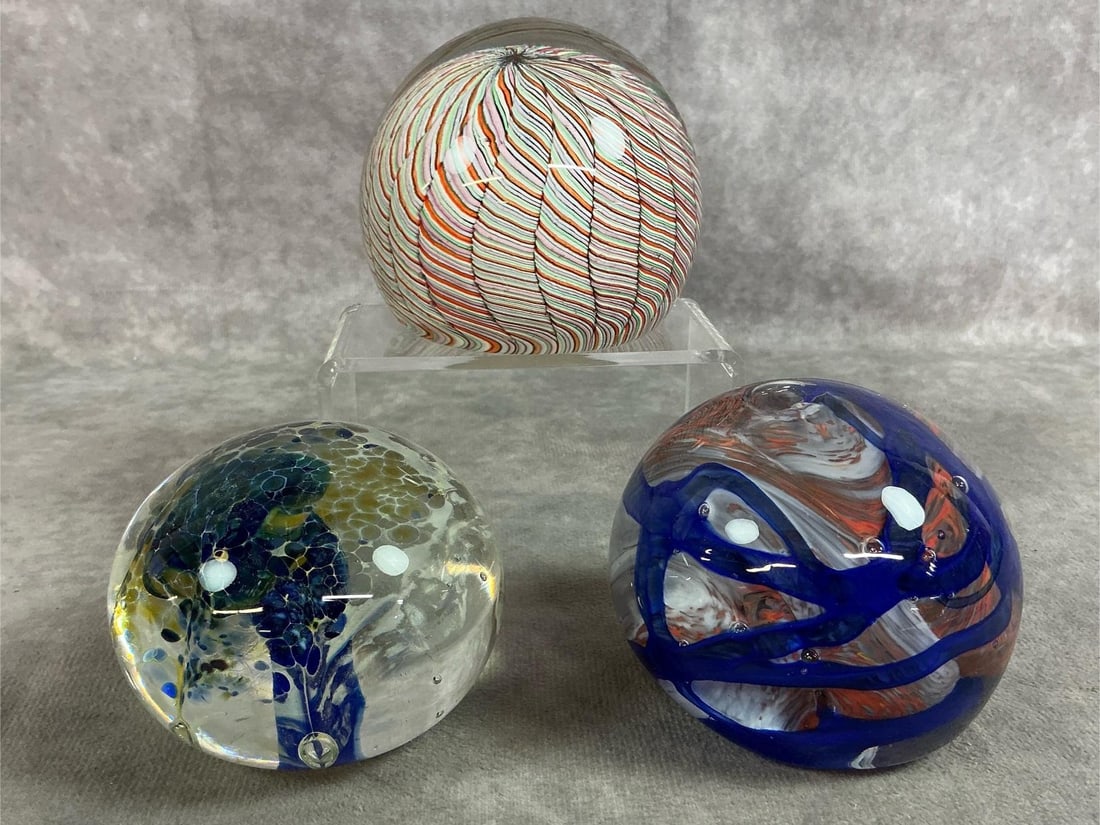 Swirled & Ribboned Paperweights: Three vintage art glass paperweights. White, orange, and lime art glass with intricate latticino ribbon technique. Also, paperweight with dark blue, white and orage swirl pattern and blue and yellow
