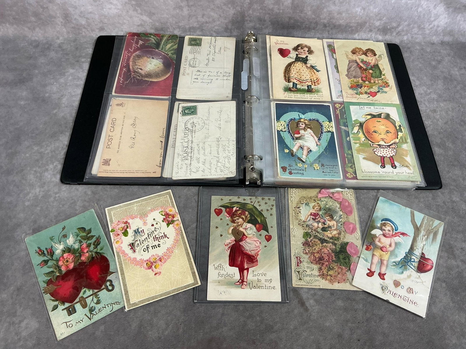 Antique Valentine Cards: Fifty early 1900's valentine cards. Cards have been posted with writing on back. Some include stamps. In binder and in good condition. Binder measures 10 inches wide x 1 x 11.5 inches tall.