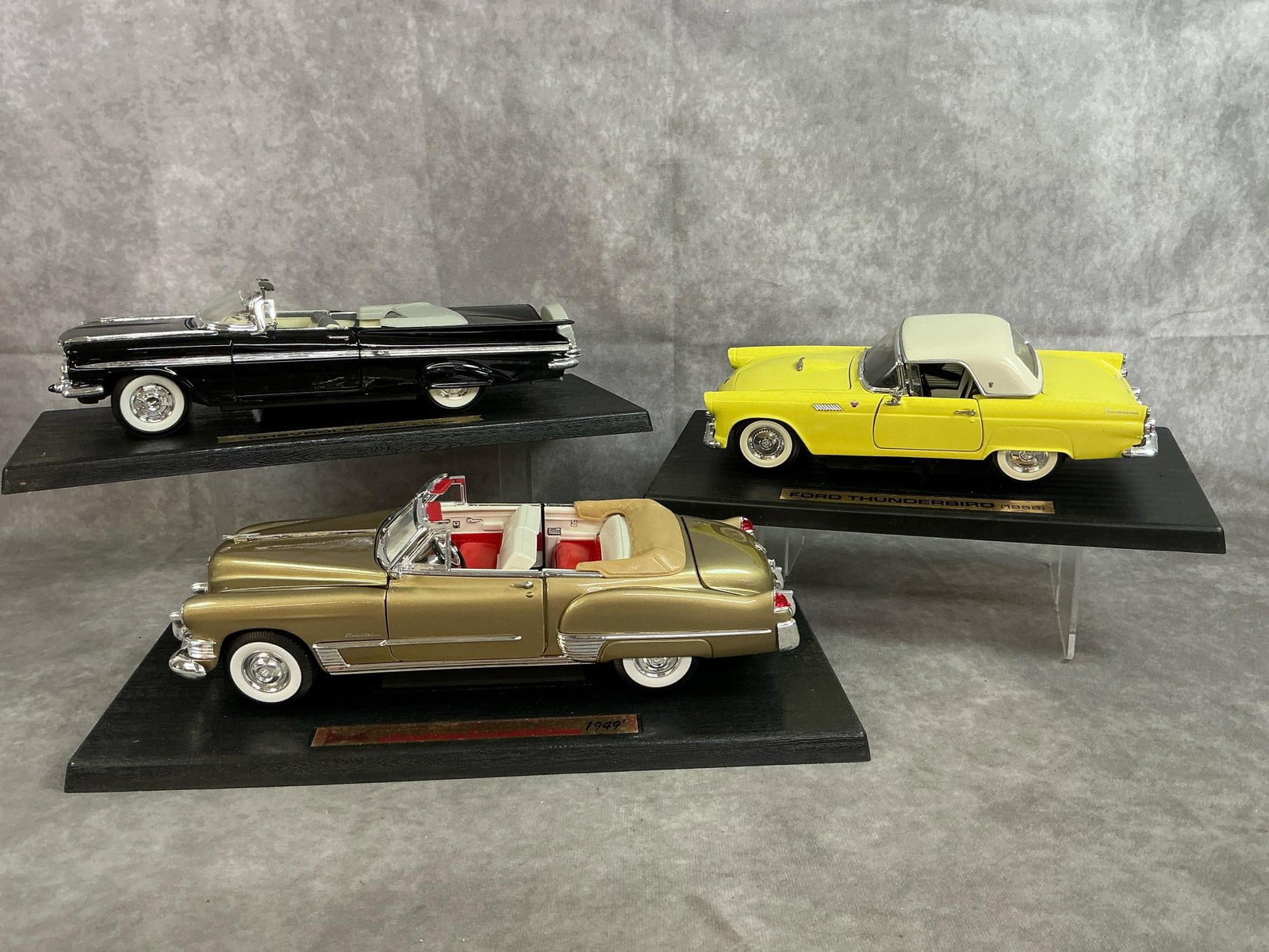 Die Cast Antique Cars: Three late 1900's collectible die-cast cars. Includes 1:18 scale Chevrolet Impala 1959, Ford Thunderbird 1955, and Cadillac Coupe de Ville 1949. Boxes are in fair condition, cars in good condition. Bo