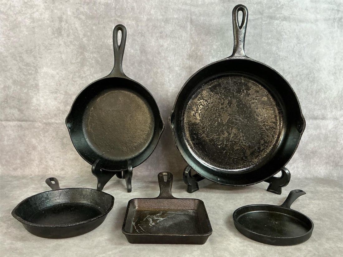 Cast Iron Skillets: Five cast iron skillets. Vintage Made In USA NO. 8 10.5 inch skillet, NO. 5 S K Made In USA, 5.5 inch Made In Taiwan, modern Lodge square pan, and one unmarked. Good used condition. Largest measures