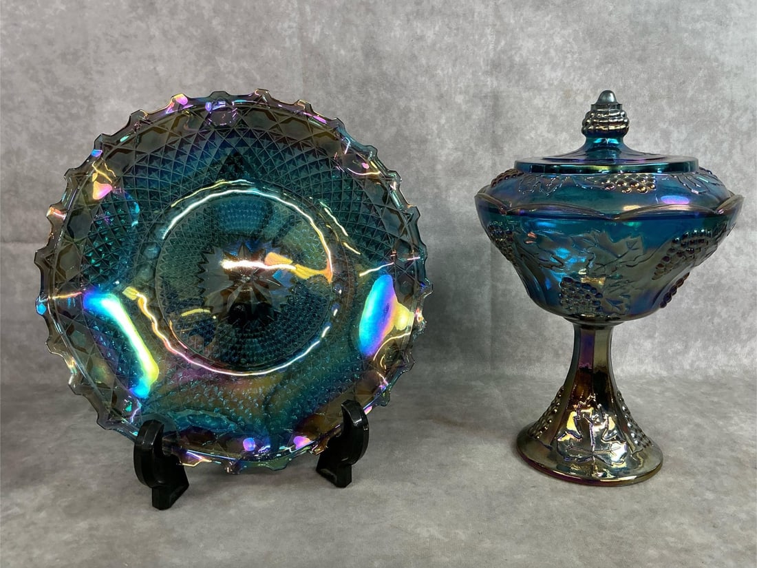 Blue Carnival Glass: Two circa 1960's Indiana iridescent blue carnival glass. One compote bowl with lid and ruffled edge bowl. Small scratch on inside of bowl otherwise both in good condition. Bowl measures 10 inches