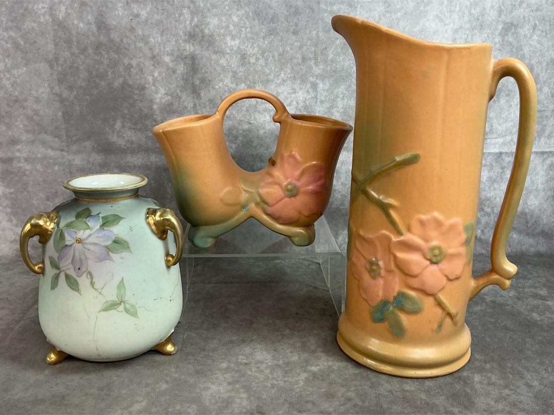 Weller Pottery & Nippon: Three early 1900's pottery and porcelain pieces. Weller Pottery pitcher and double vase with Wild Rose pattern and peach colored glaze. Includes porcelain Nippon pale green with floral motif and gold 