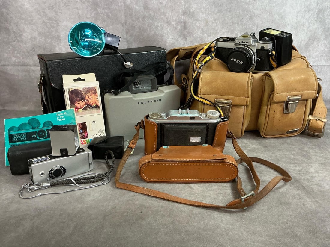 Vintage Cameras & Accessories: Four mid 1900's cameras, attachments and cases. Includes Nikon FE 35mm with electronic shoe mount flash and tan gadget bag. Agfa Isolette 35 mm camera in leather case, Polaroid 104 automatic Land came