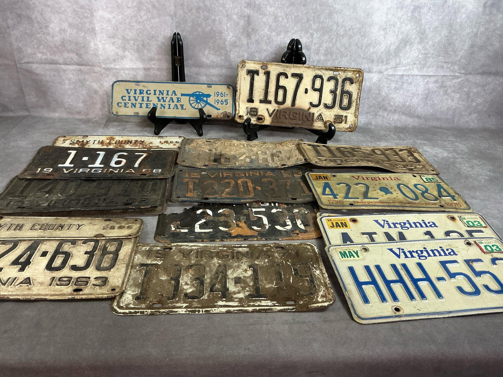 Collectible License Plates: Fourteen Virginia license plates, two Smyth County plates, and Civil War Centennial plate. Plates range from 1951- 2003. Rust present and several in poor condition. Average plate measures 12 inches