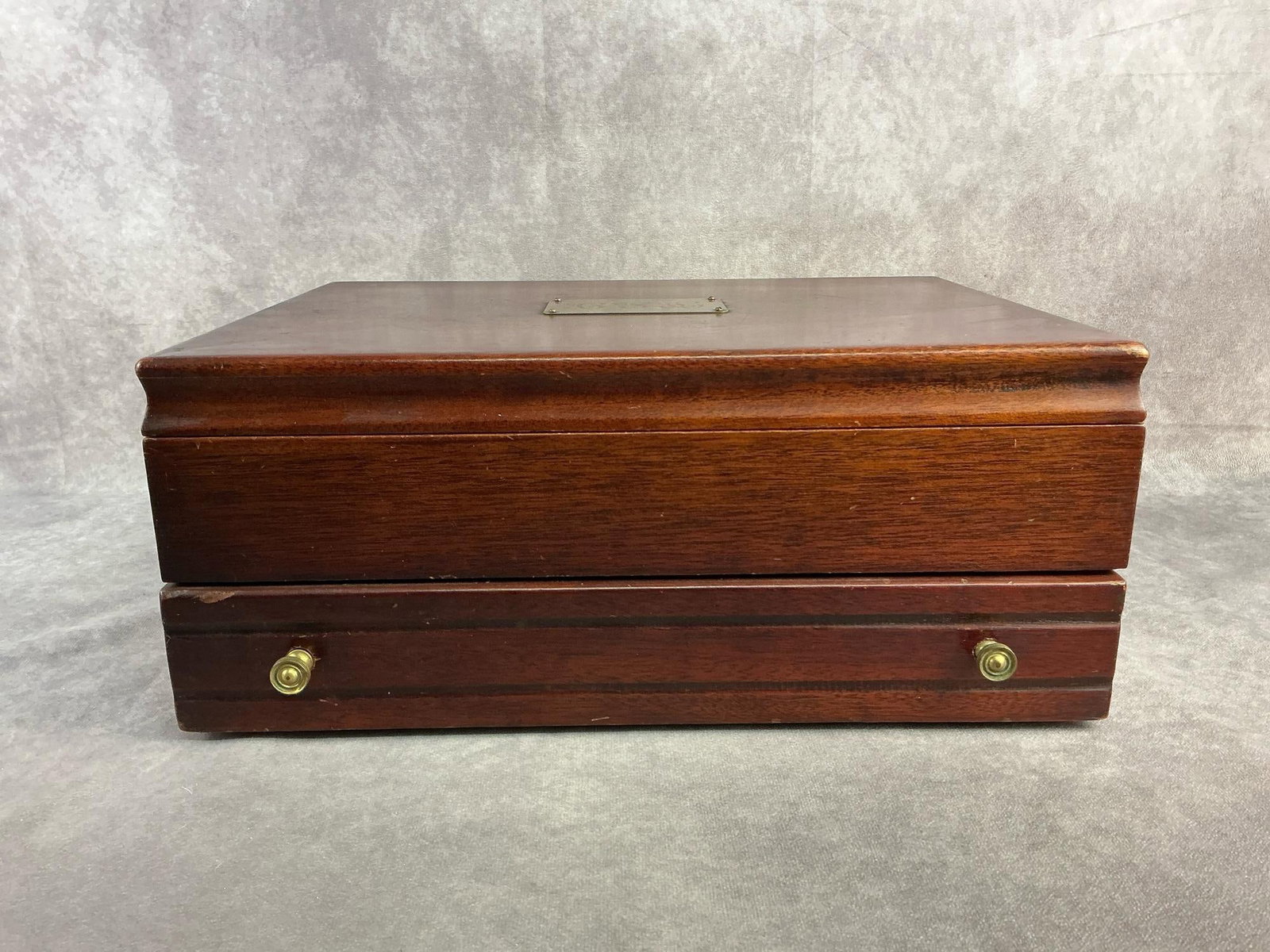 Silverware Chest: Pacific wood silverware chest that helps prevent tarnish. In good condition with two lower knobs on drawer broken. Measures 16 inches wide x 11.5 inches x 6.75 inches tall.